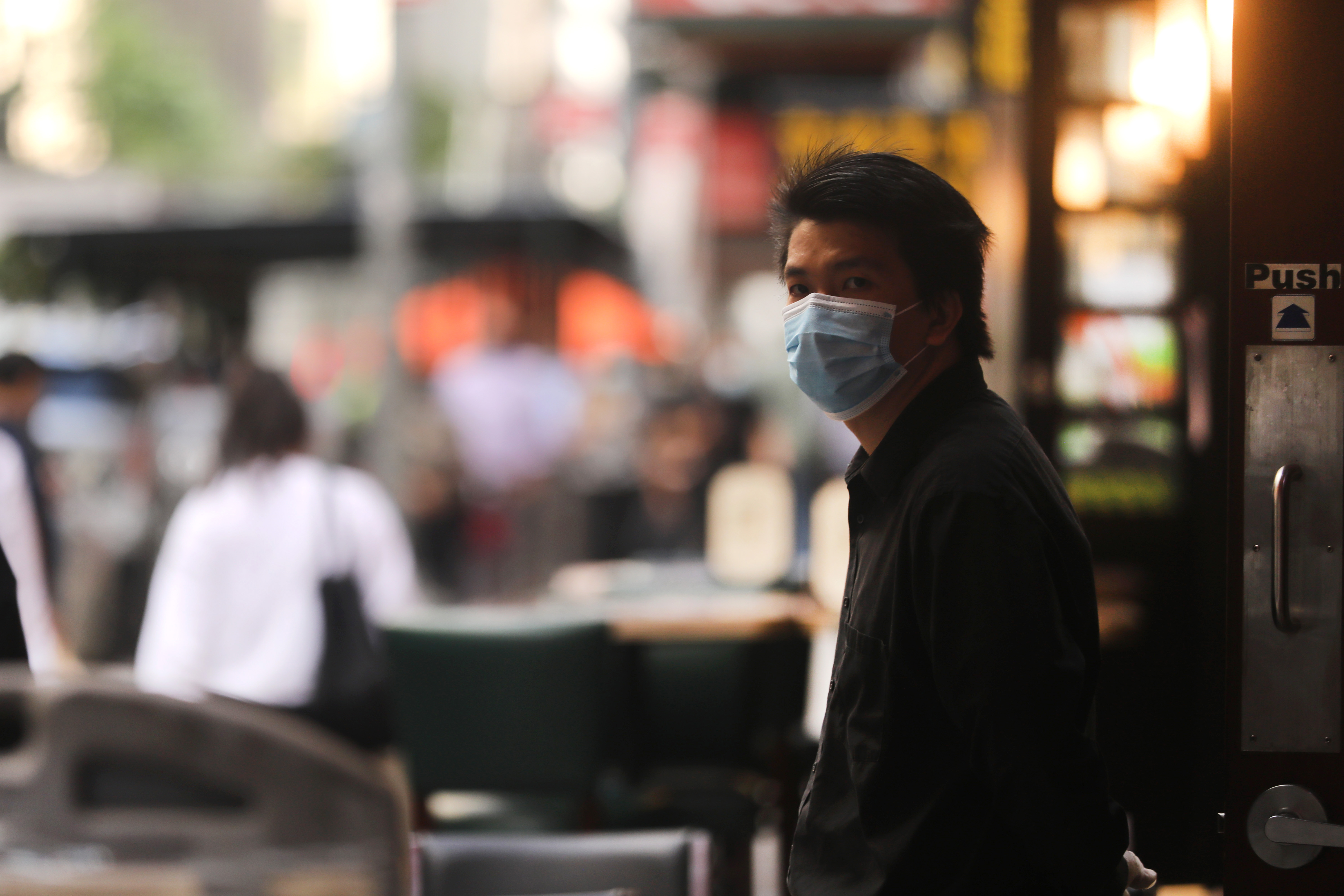 NEW YORK, NEW YORK - SEPTEMBER 30: A waiter stands outside of a restaurant as New York City eateries are allowed to open their doors to 25 percent capacity on September 30, 2020 in New York City. As some customers return to indoor dining, they will be met with plastic partitions, hand sanitizer, masks and gloves. The city says that 50 percent capacity will follow shortly. (Photo by Spencer Platt/Getty Images)