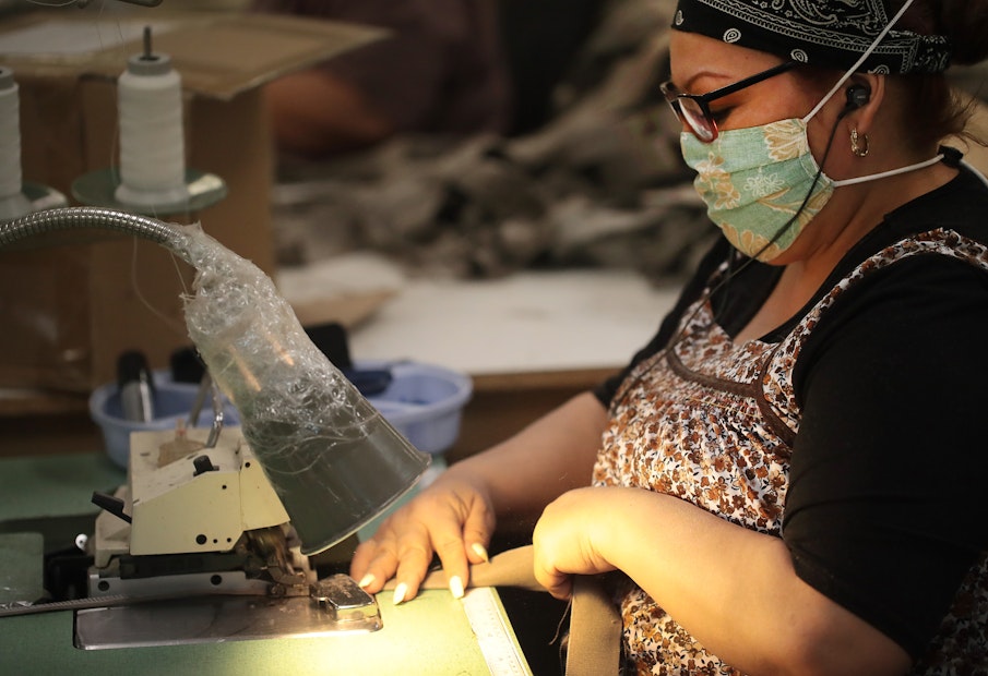 A lady sewing in a factory