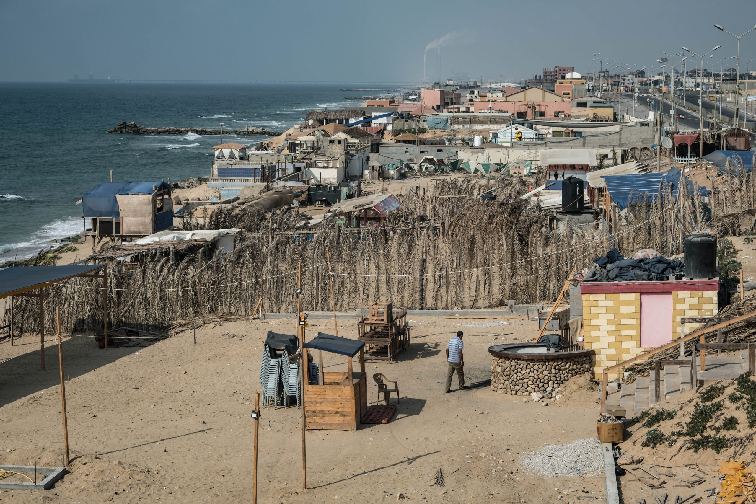 GAZA CITY, GAZA - AUGUST 30: A man leaves after closing his cafe on the corniche of the Gaza Strip, due to the coronavirus lockdown on August 30, 2020 in Gaza City, Gaza. Fears are growing that the already crippled health care system will not be able to cope, as coronavirus cases continue to rise throughout the Gaza strip. In the past weeks Israel has responded to incendiary balloons launched from Gaza, with airstrikes and further blockade restrictions adding to the pressure on residents already struggling with just four hours of electricity a day. In the past week, the Ministry of Health and Security Services in the Gaza Strip have issued strict lockdown and movement restrictions, to try to contain the rising infections. On August 31, Hamas agreed to temporarily end hostilities with Israel in exchange for a cash infusion from Qatar and an agreement with Israel to once again allow fuel to Gaza’s power station in a bid to calm the ongoing situation and deal with the latest coronavirus outbreak. Since March, there have reportedly been over 500 coronavirus cases with 5 confirmed deaths in the Gaza strip.  (Photo by Fatima Shbair/Getty Images)