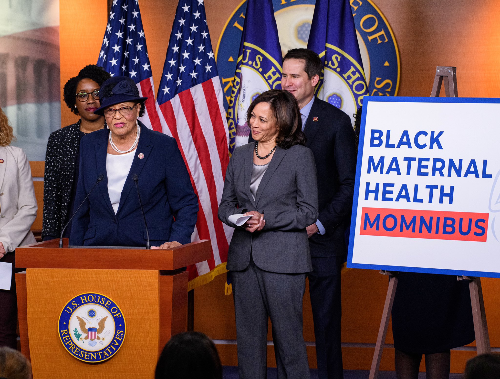 a group of people standing behind a podium
