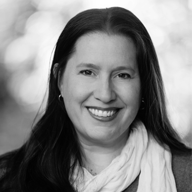 a black and white photo of a smiling woman