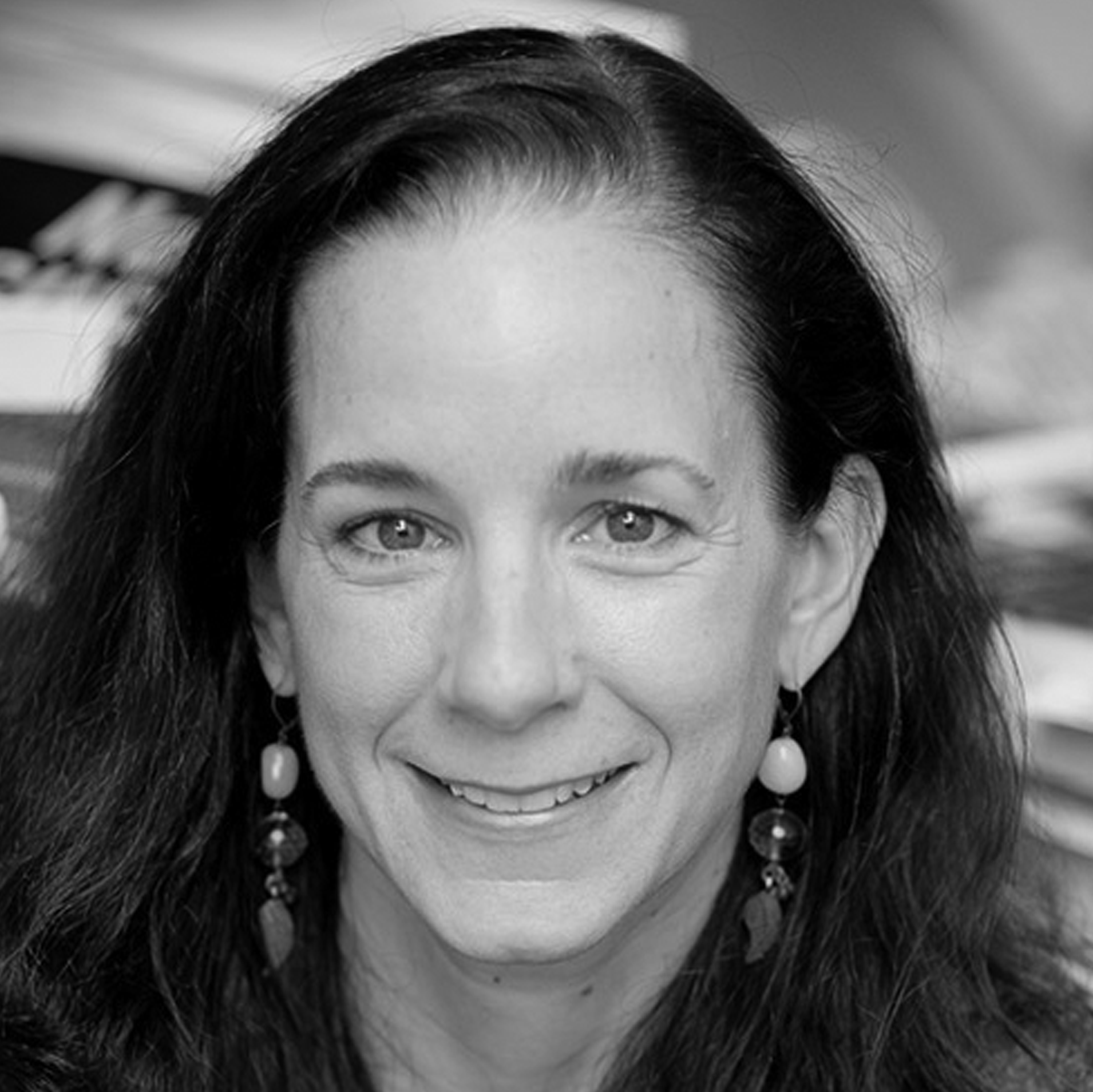 a black and white photo of a woman smiling