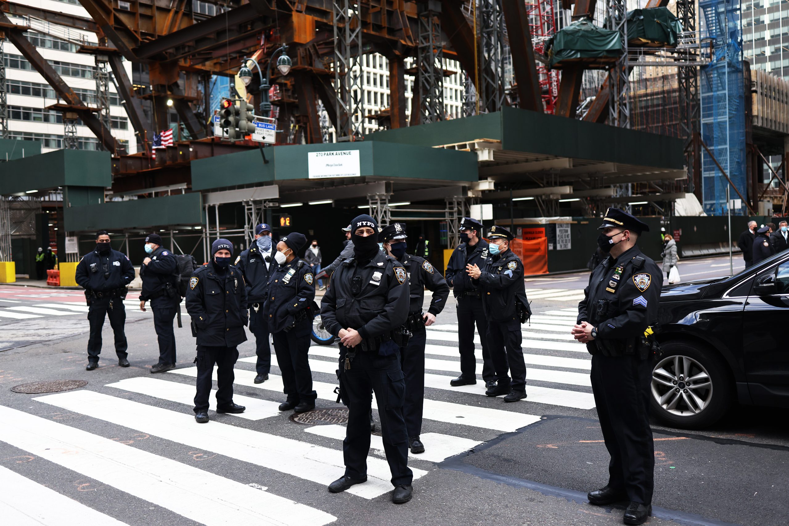 NEW YORK, NEW YORK - APRIL 02: NYPD officers stand watch after a person fell while climbing the side of a Chase Bank location as demonstrators gather in Midtown Manhattan on April 02, 2021 in New York City. Members of the Extinction Rebellion NYC and various organizations held a rally and a march in solidarity with the #StopTheMoneyPipeline coalition, urging President Joe Biden to stop the construction of the Line 3 pipeline in Minnesota. (Photo by Michael M. Santiago/Getty Images)