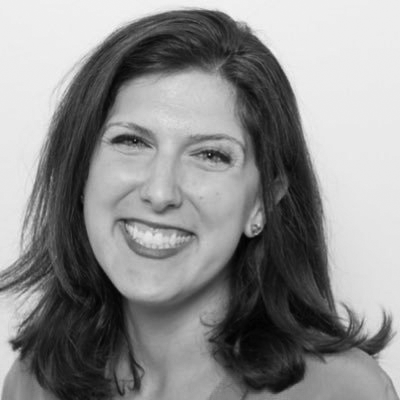 a black and white photo of a woman smiling