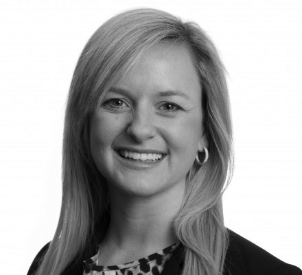 a black and white photo of a woman smiling