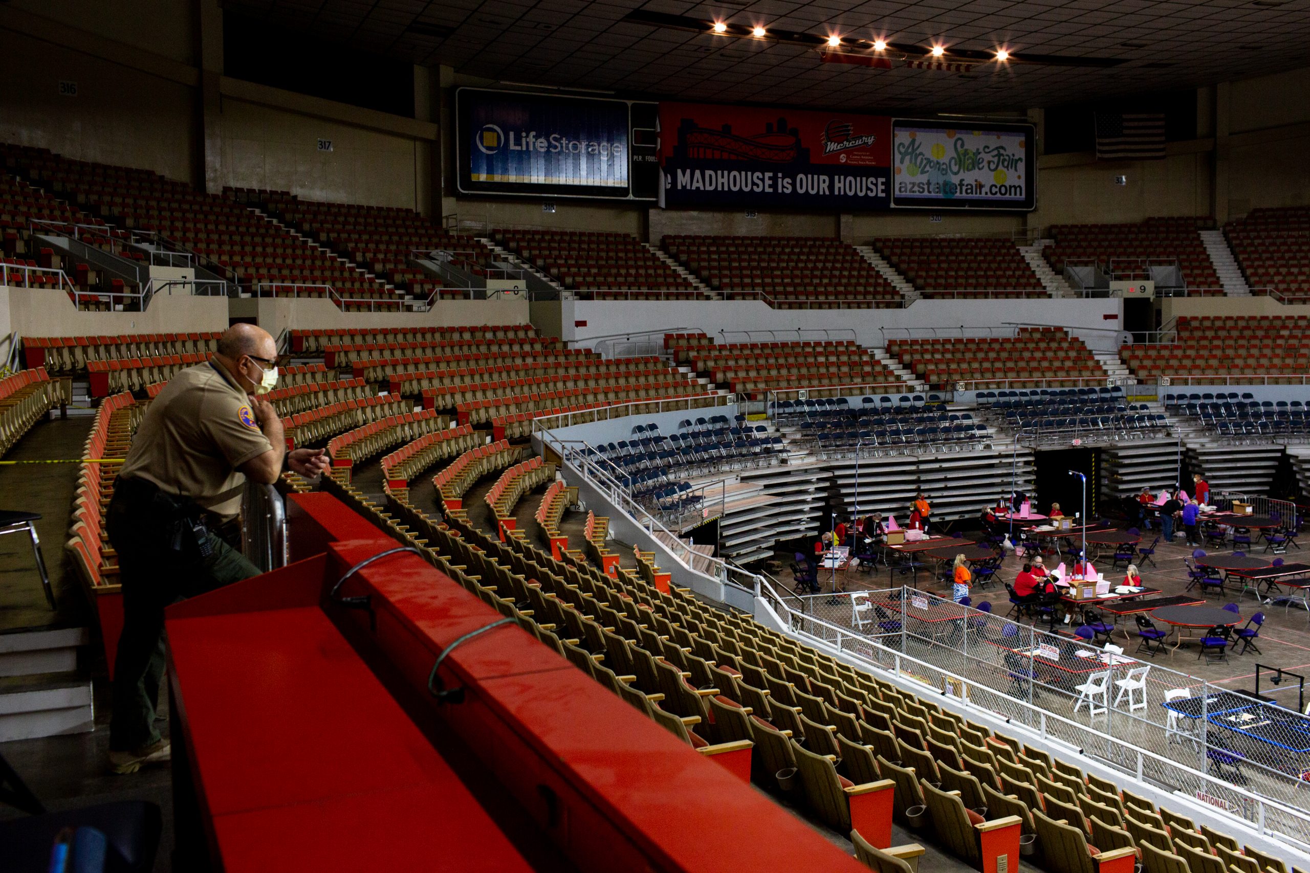PHOENIX, AZ - MAY 01: An Arizona Rangers watches as contractors working for Cyber Ninjas, who was hired by the Arizona State Senate, examine and recount ballots from the 2020 general election at Veterans Memorial Coliseum on May 1, 2021 in Phoenix, Arizona. The Maricopa County ballot recount comes after two election audits found no evidence of widespread fraud.  (Photo by Courtney Pedroza/Getty Images)