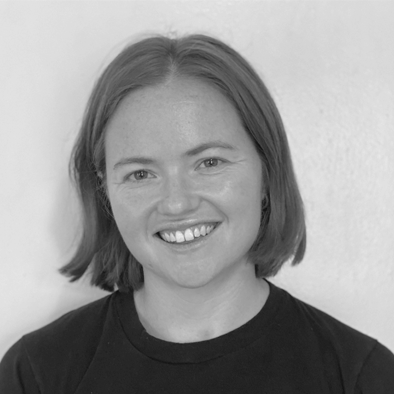 a black and white photo of a woman smilingf