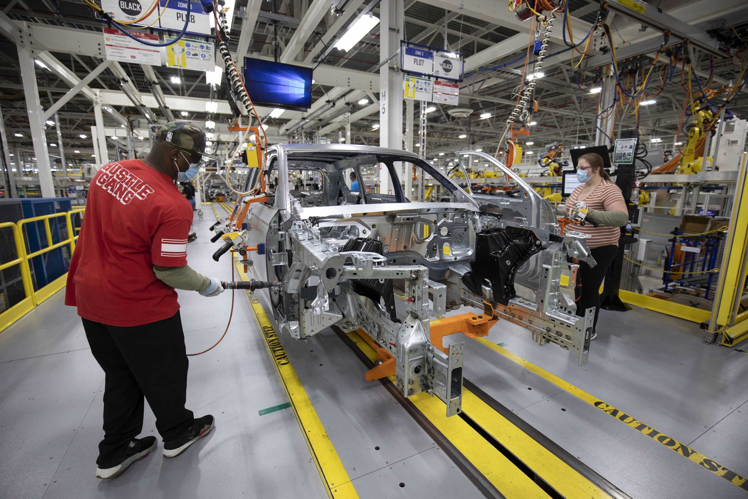 DETROIT, MI - JUNE 10:  Stellantis workers install doors on a 2021 Jeep Grand Cherokee L at the Stellantis Detroit Assembly Complex-Mack on June 10, 2021 in Detroit, Michigan. The plant is the first new auto assembly plant in Detroit in thirty years, and will manufacture the 2021 Jeep Grand Cherokee L. (Photo by Bill Pugliano/Getty Images)