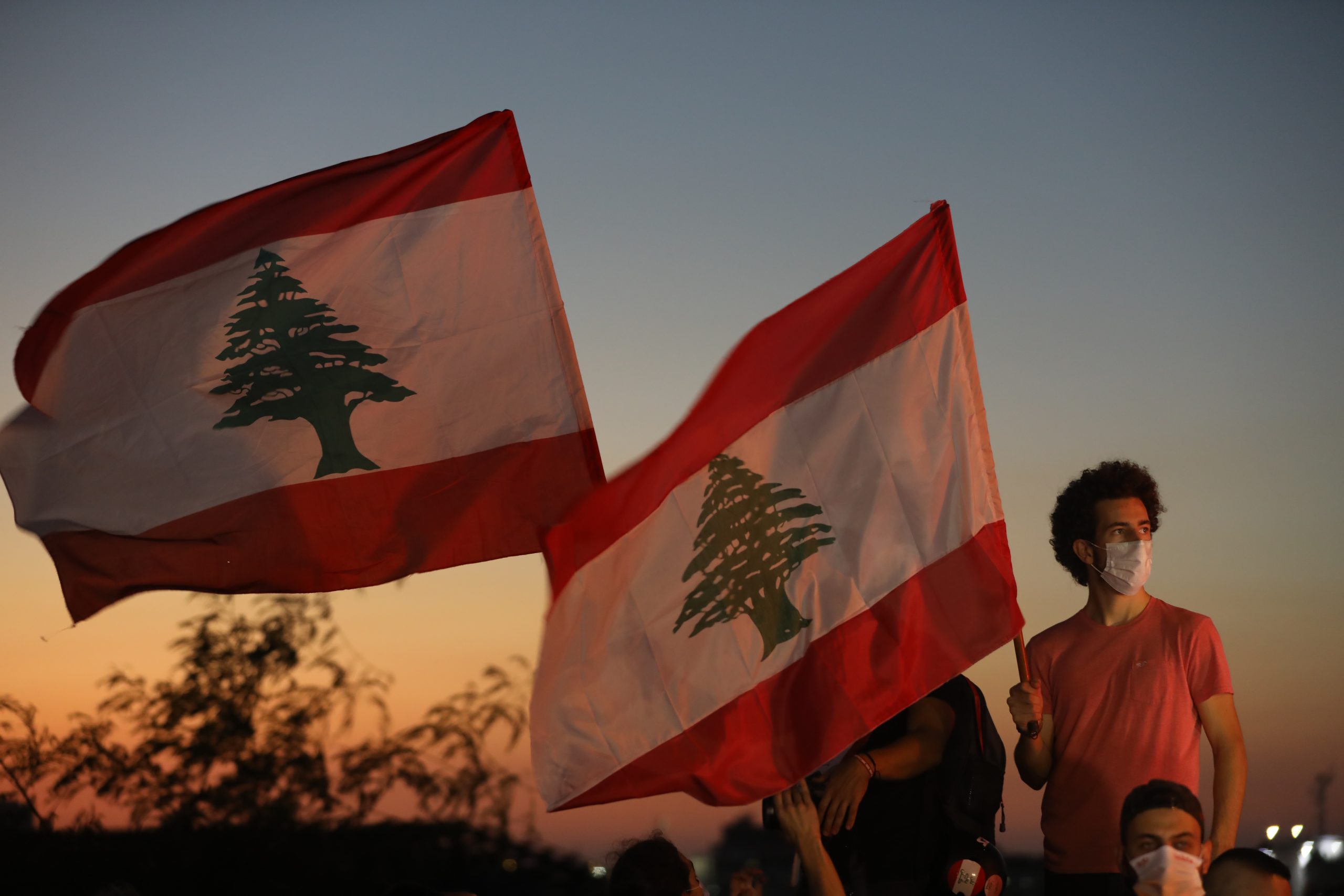BEIRUT, LEBANON - OCTOBER 17: People wave Lebanese flags and chant to mark the one-year anniversary of anti-government protests on October 17, 2020 in Beirut, Lebanon. On the one year anniversary since the unprecedented mass protests of Lebanese demanding political change as the country buckled under social and economic devastation, Beirut remains in rubble after the August 4 port blast. (Photo by Marwan Tahtah/Getty Images)