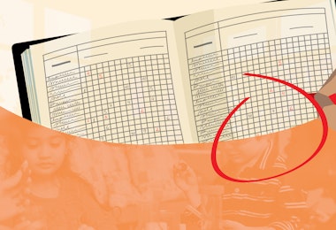 a hand is holding a pencil and a book