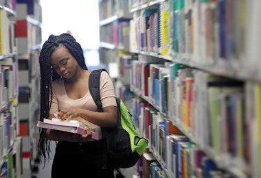 lady holding books in a library