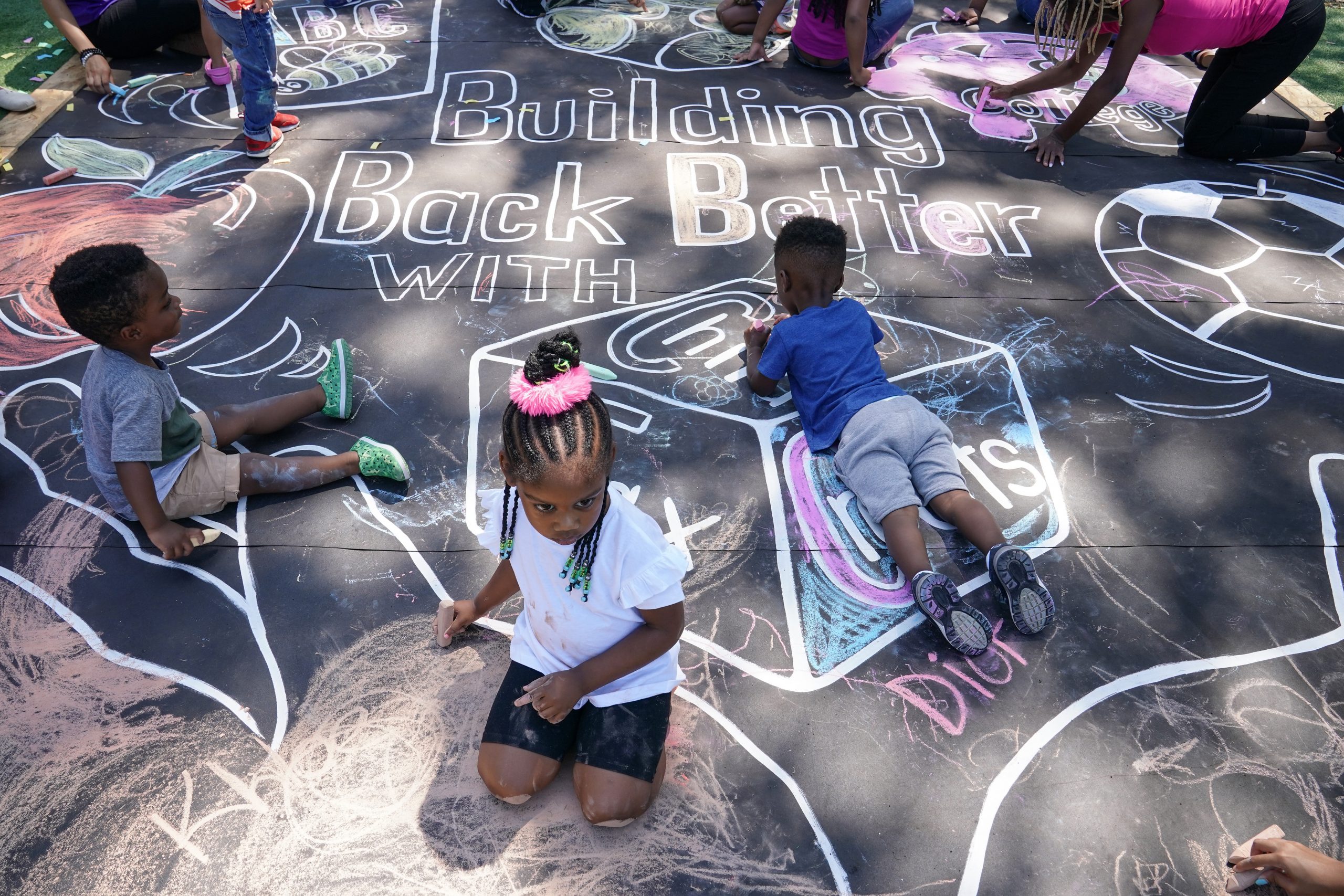 WASHINGTON, DC - JULY 14: Children and teachers from the KU Kids Deanwood Childcare Center complete a mural in celebration of the launch of the Child Tax Credit on July 14, 2021 at the KU Kids Deanwood Childcare Center in Washington, DC. (Photo by Jemal Countess/Getty Images for Community Change)