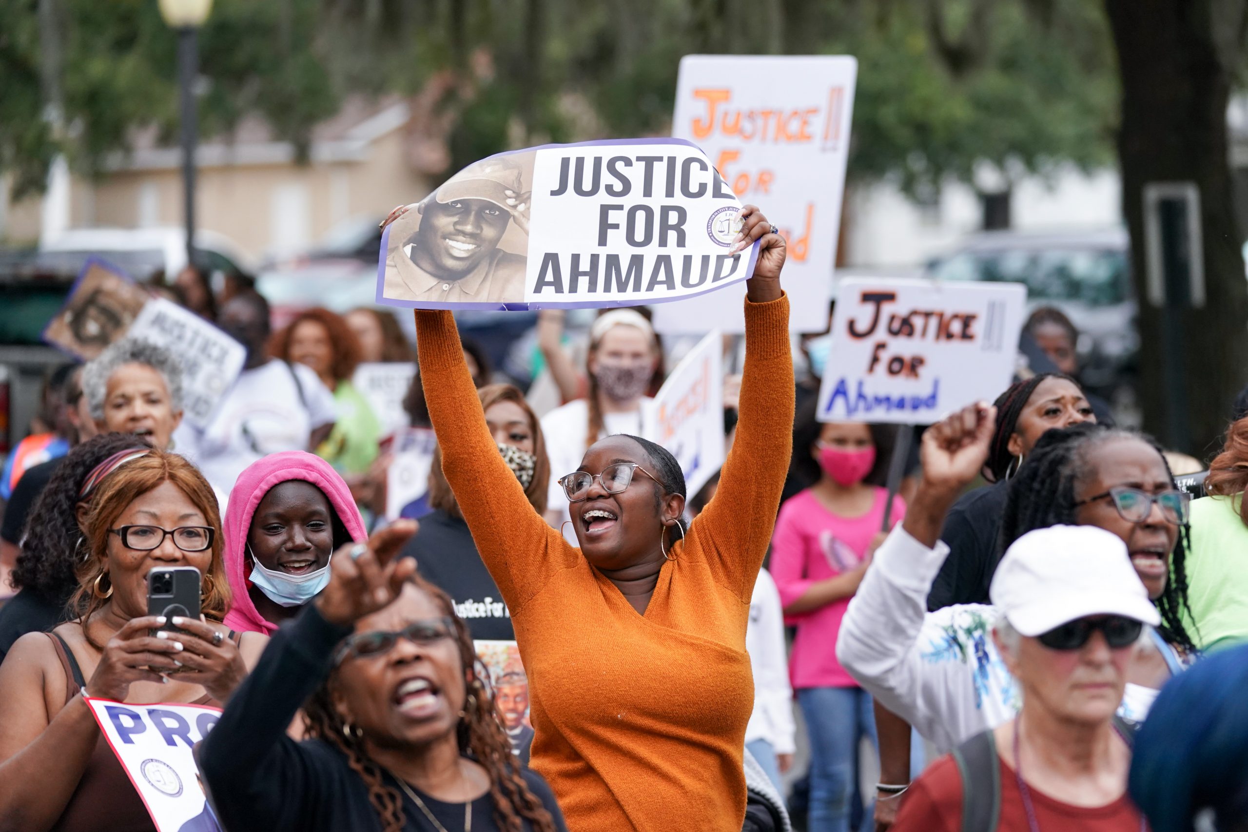 BRUNSWICK, GA - NOVEMBER 18: Demonstrators march near the Glynn County Courthouse after the adjournment of daily court proceedings in the trial for the killers of Ahmaud Arbery on November 18, 2021 in Brunswick, Georgia. Greg McMichael, his son Travis McMichael, and a neighbor, William 