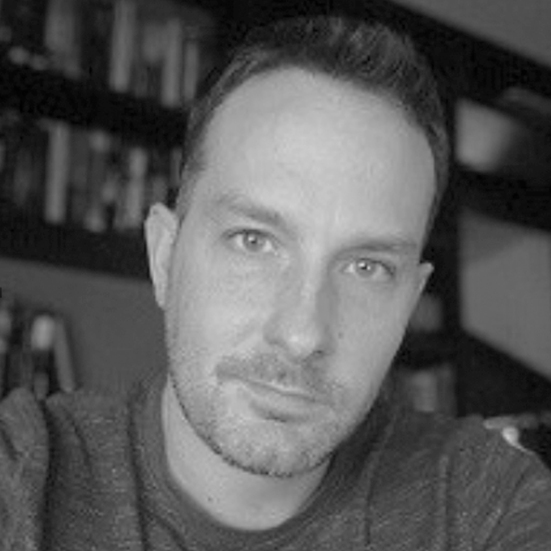 a black and white photo of a smiling man