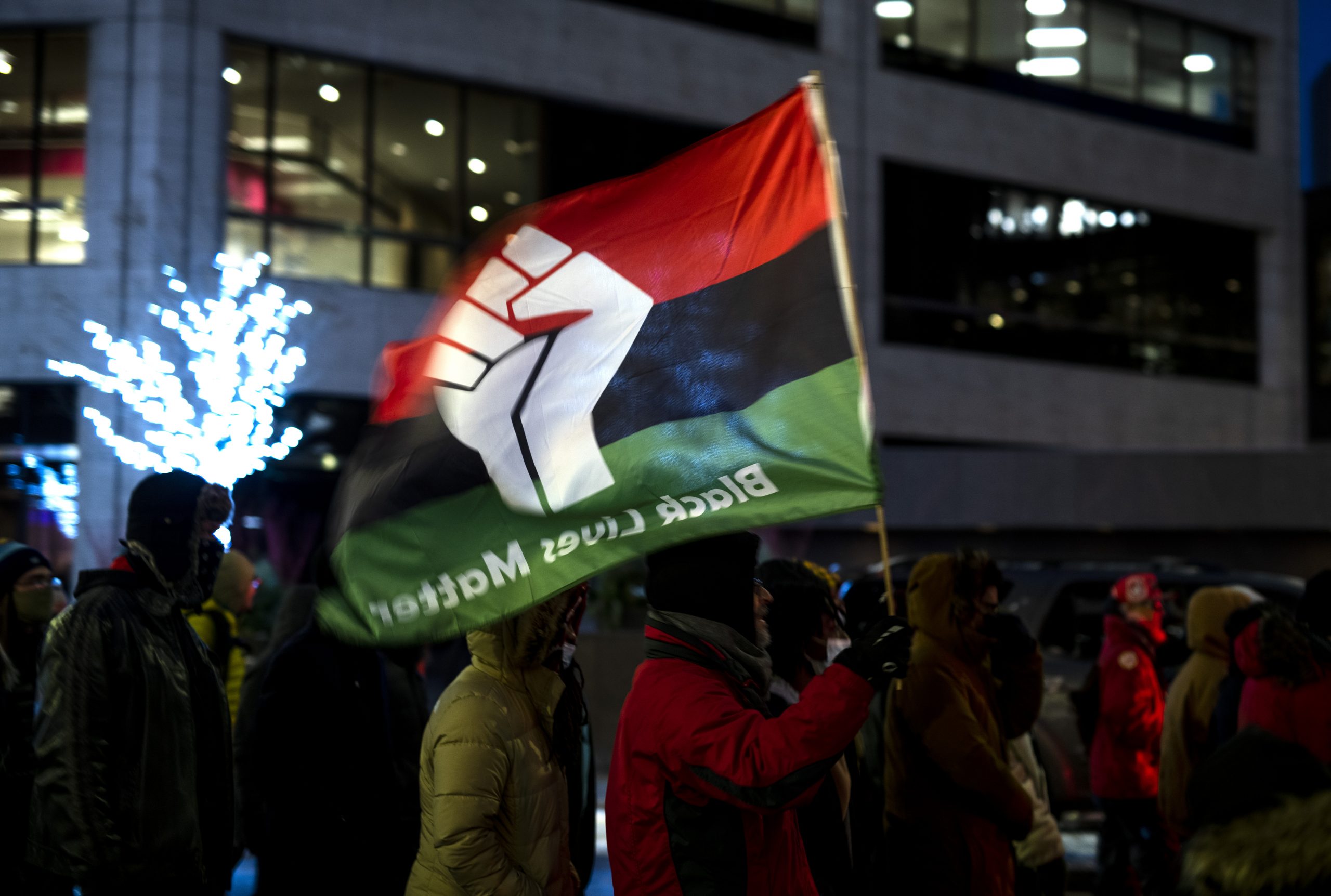 MINNEAPOLIS, MN - DECEMBER 08: Protesters march in the streets near the Hennepin County Government Center on December 8, 2021 in Minneapolis, Minnesota. Opening statements began today in the trial of former Brooklyn Center police officer Kim Potter, who is charged with manslaughter in the April 2021 shooting death of Daunte Wright. Potter says she thought she was using her Taser when she shot Wright with her handgun. (Photo by Stephen Maturen/Getty Images)