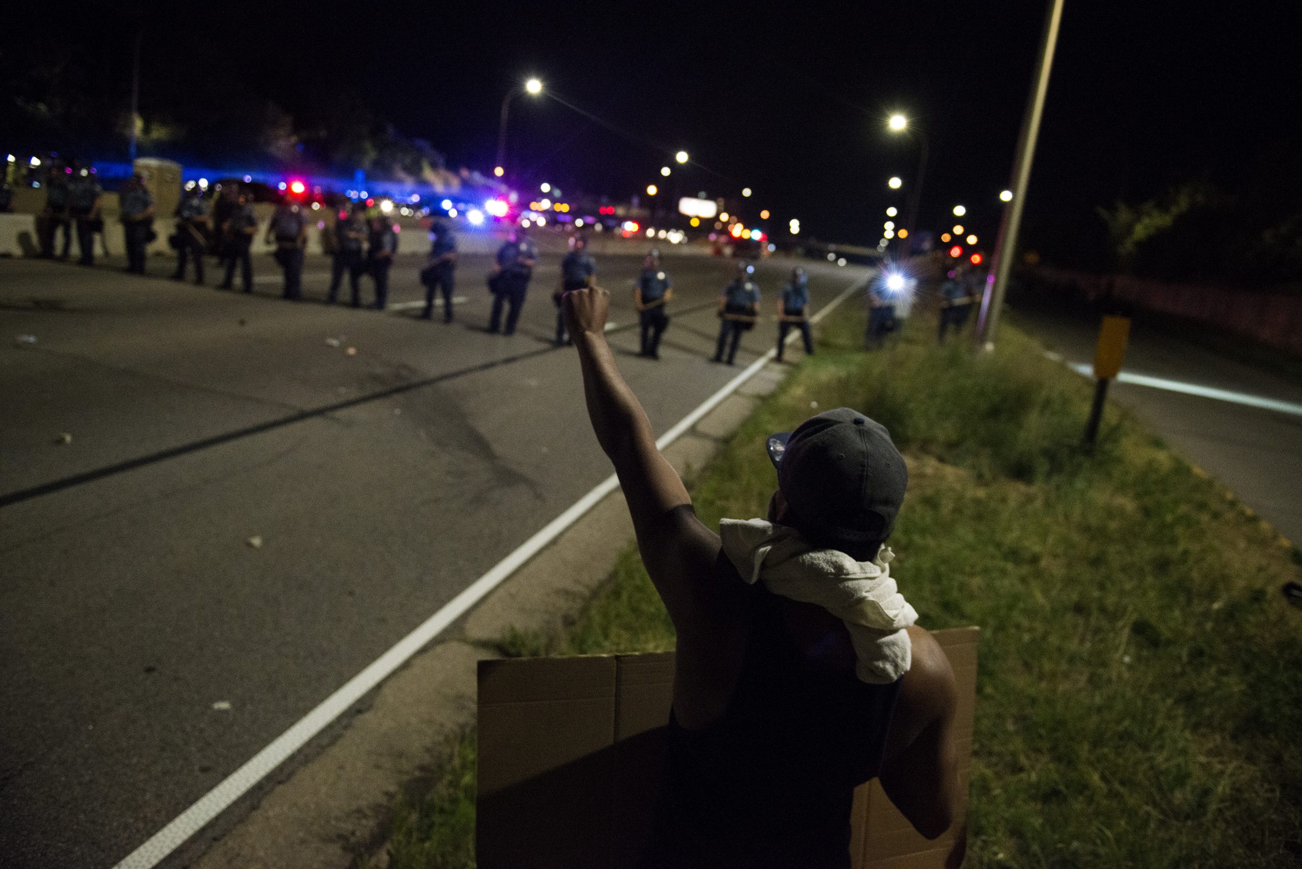 ST. PAUL, MN - JULY 09: A protestor raises his fist on shut down highway I-94 on July 9, 2016 in St. Paul, Minnesota. Protests and marches have occurred every day since the police killing of Philando Castile on June 6, 2016 in Falcon Heights, Minnesota. (Photo by Stephen Maturen/Getty Images)