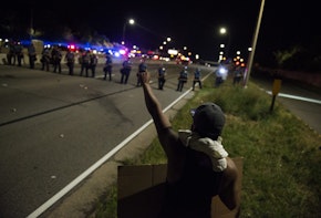 ST. PAUL, MN - JULY 09: A protestor raises his fist on shut down highway I-94 on July 9, 2016 in St. Paul, Minnesota. Protests and marches have occurred every day since the police killing of Philando Castile on June 6, 2016 in Falcon Heights, Minnesota. (Photo by Stephen Maturen/Getty Images)