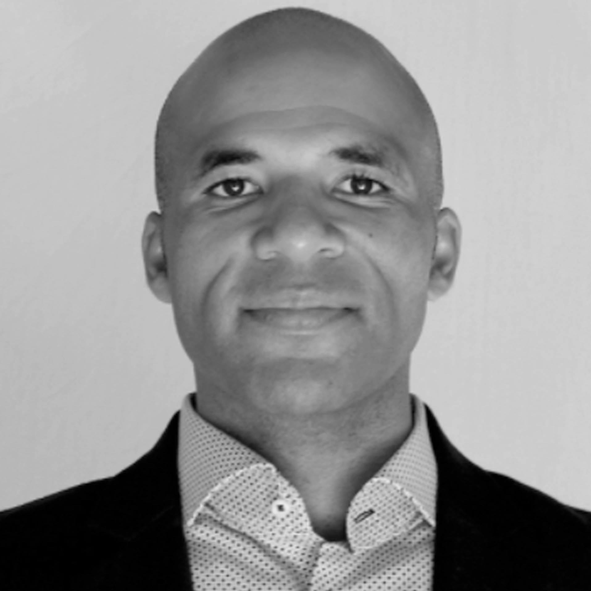 a black and white photo of a man in a suit