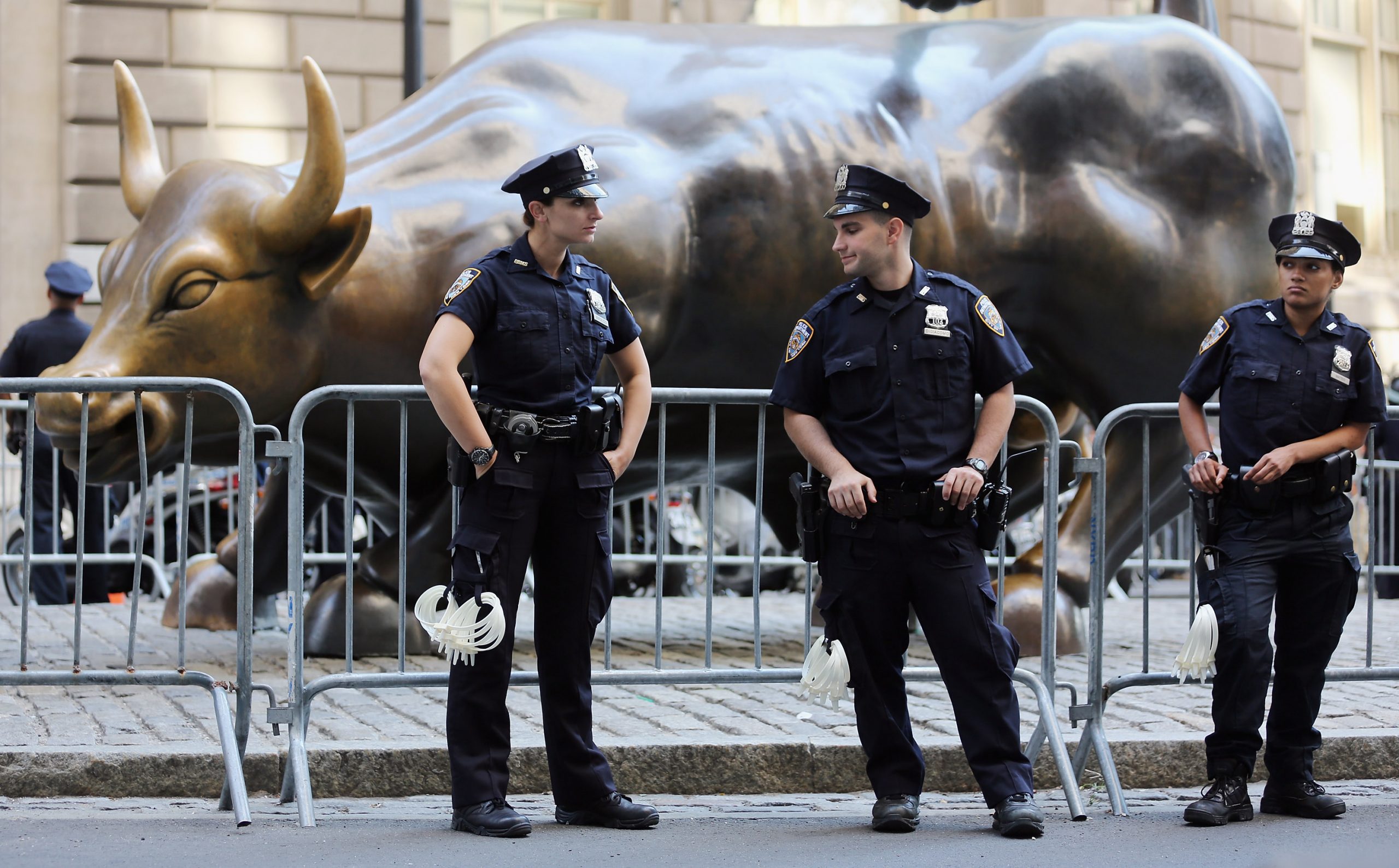 NEW YORK, NY - SEPTEMBER 17:  Police guard the famous bull statue during Occupy Wall Street protests in the Financial District on September 17, 2012 in New York City. Today is the one year anniversary of Occupy Wall Street and protesters are planning various actions and events throughout the day.  (Photo by Mario Tama/Getty Images)
