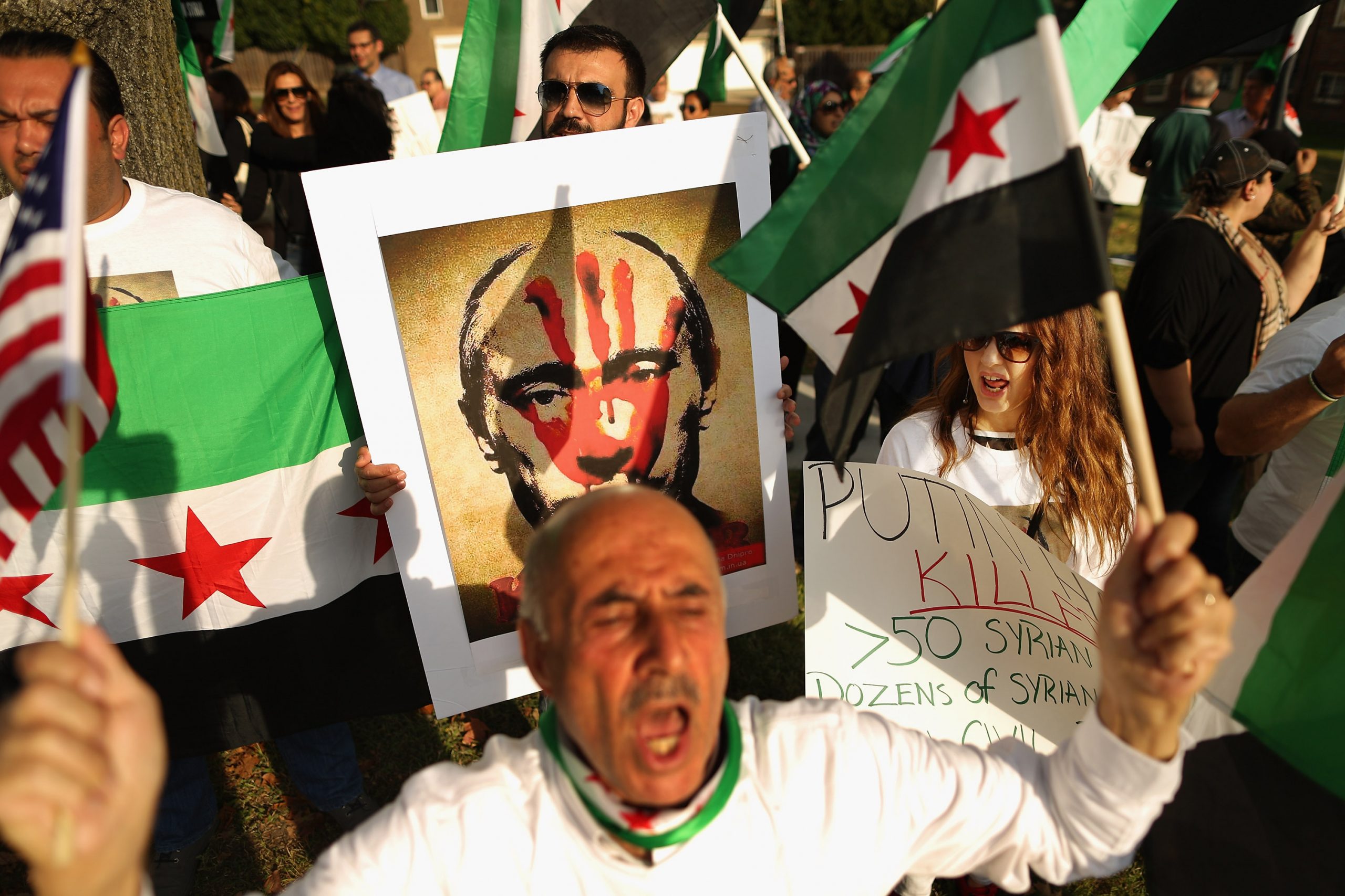 WASHINGTON, DC - OCTOBER 09:  About 100 people shout slogans as they gather outside the Russian embassy to protest against President Vladamir Putin and his country's involvement in Syria October 9, 2015 in Washington, DC. Syrian Americans and supporters of the Syrian people gathered to demonstrate against Russia's military build up and action in Syria and its four-year civil war.  (Photo by Chip Somodevilla/Getty Images)