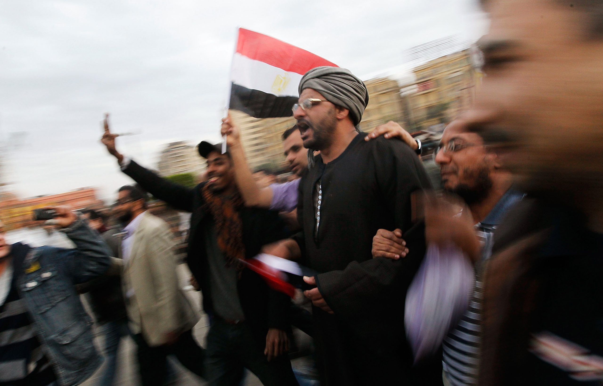 CAIRO, EGYPT - FEBRUARY 04:  Anti-government protesters march in Tahrir Square February 4, 2011 in Cairo, Egypt.  Clashes between anti- and pro-government factions in Egypt's central square quieted February 4, as anti-government protesters called for a 