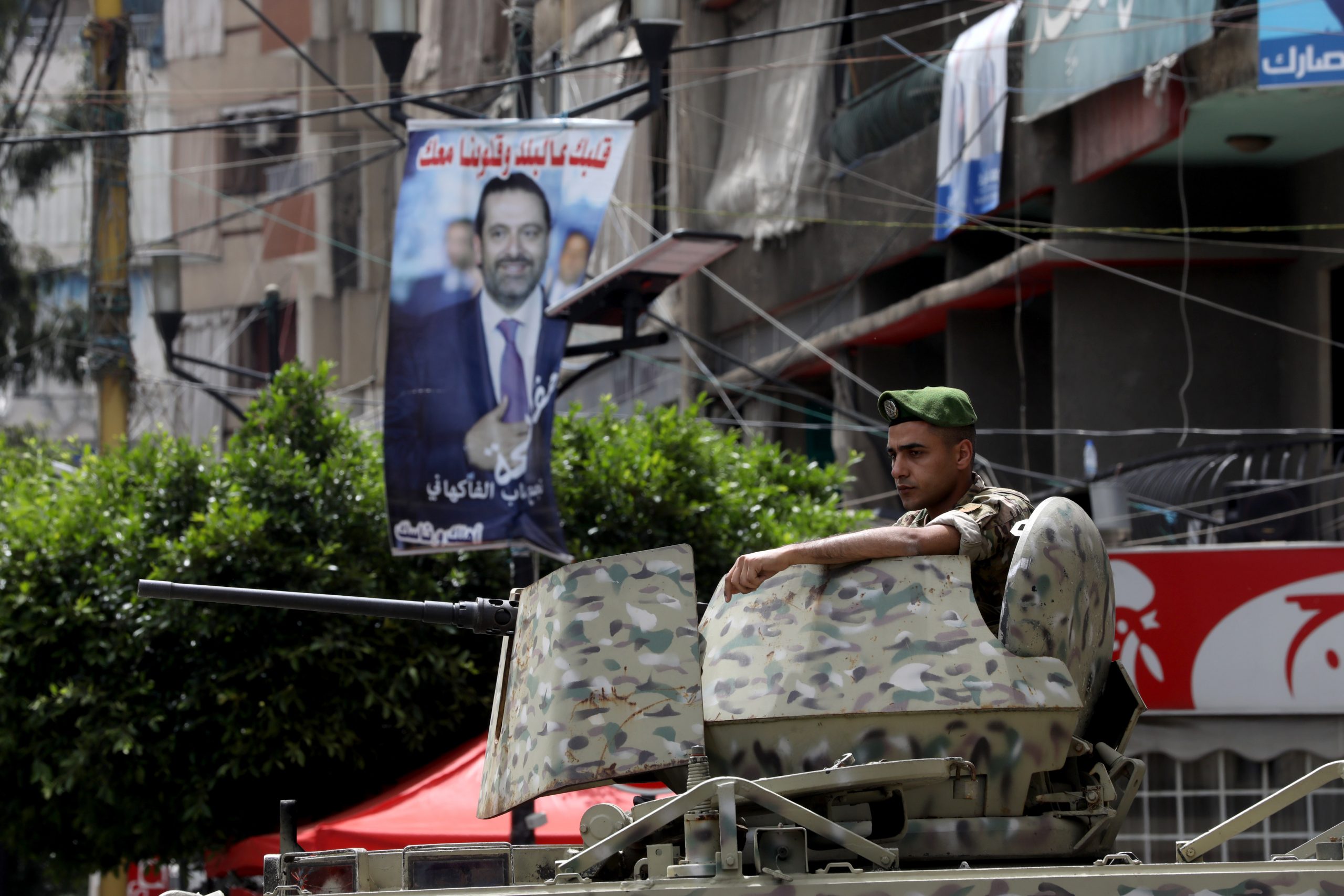 BEIRUT, LEBANON - MAY 15: A soldier stands guard near a poster featuring former prime minister Rafic Hariri on May 15, 2022 in the Tarik El Jdideh neighborhood of Beirut, Lebanon. Lebanese head to the polls for the first time since the protest movement of 2019, and amid the country's continued financial crisis. (Photo by Marwan Tahtah/Getty Images)