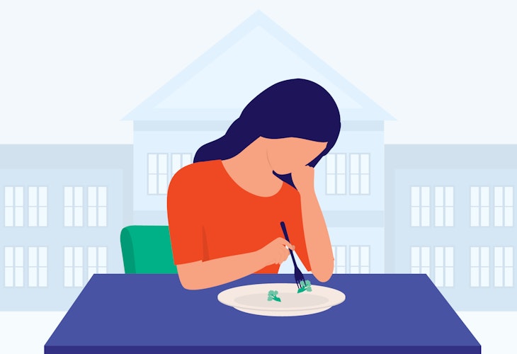 A student looks over their plate, which is mostly empty.