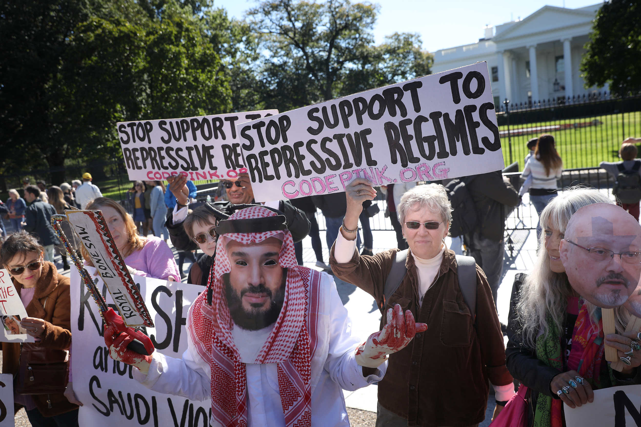 WASHINGTON, DC - OCTOBER 19: A protester dressed as Saudi Arabian crown prince Mohammad bin Salman, demonstrates with members of the group Code Pink outside the White House in the wake of the disappearance of Saudi Arabian journalist Jamal Khashoggi October 19, 2018 in Washington, DC. Khashoggi has disappeared following a meeting at the Saudi consulate in Istanbul on October 2, 2018. (Photo by Win McNamee/Getty Images)