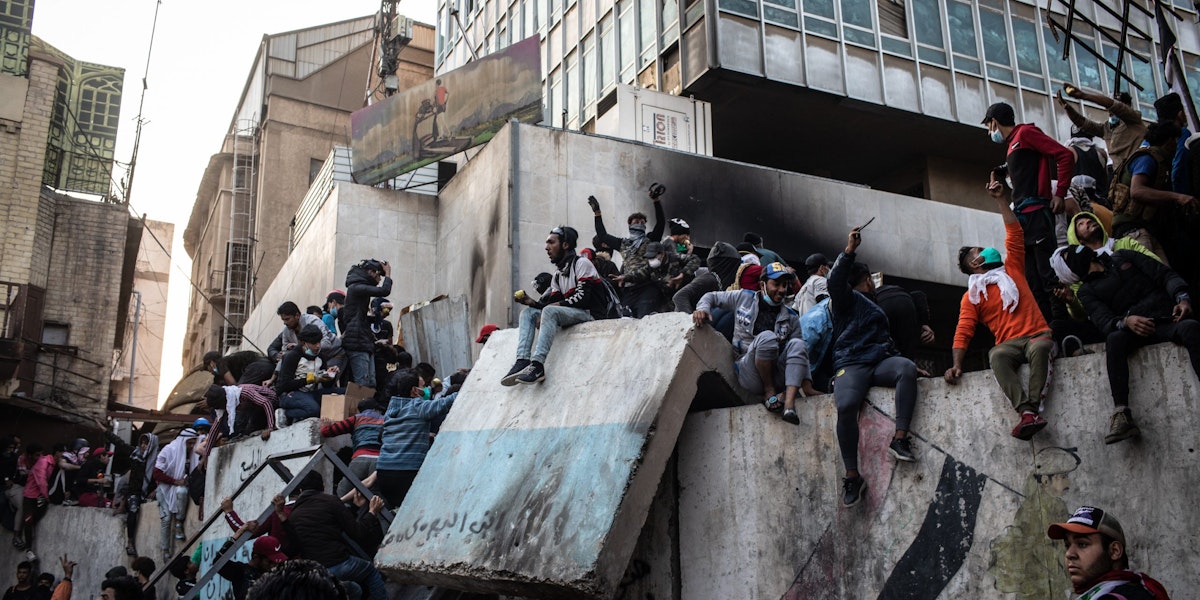 BAGHDAD, IRAQ - NOVEMBER 24: Demonstrators gather on a barricade near Ahrar Bridge where there have been recent clashes between demonstrators and Iraq security forces on Nov. 24, 2019 in Baghdad, Iraq. Thousands of demonstrators have occupied Baghdad's center Tahrir Square and central Baghdad since October 1, calling for government and policy reform. (Photo by Erin Trieb/Getty Images)