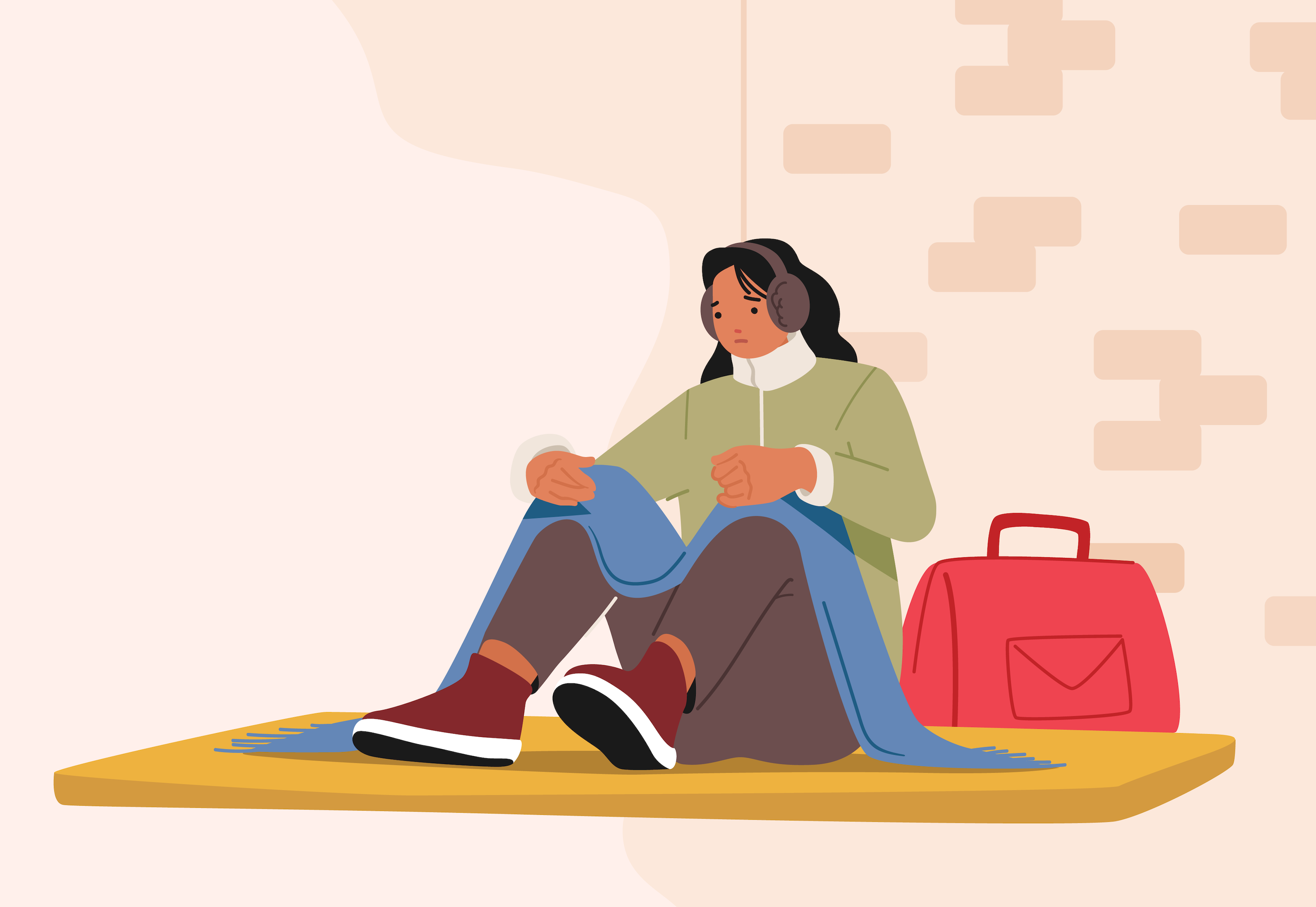 A person who was recently unhoused is sitting outside with their belongings.