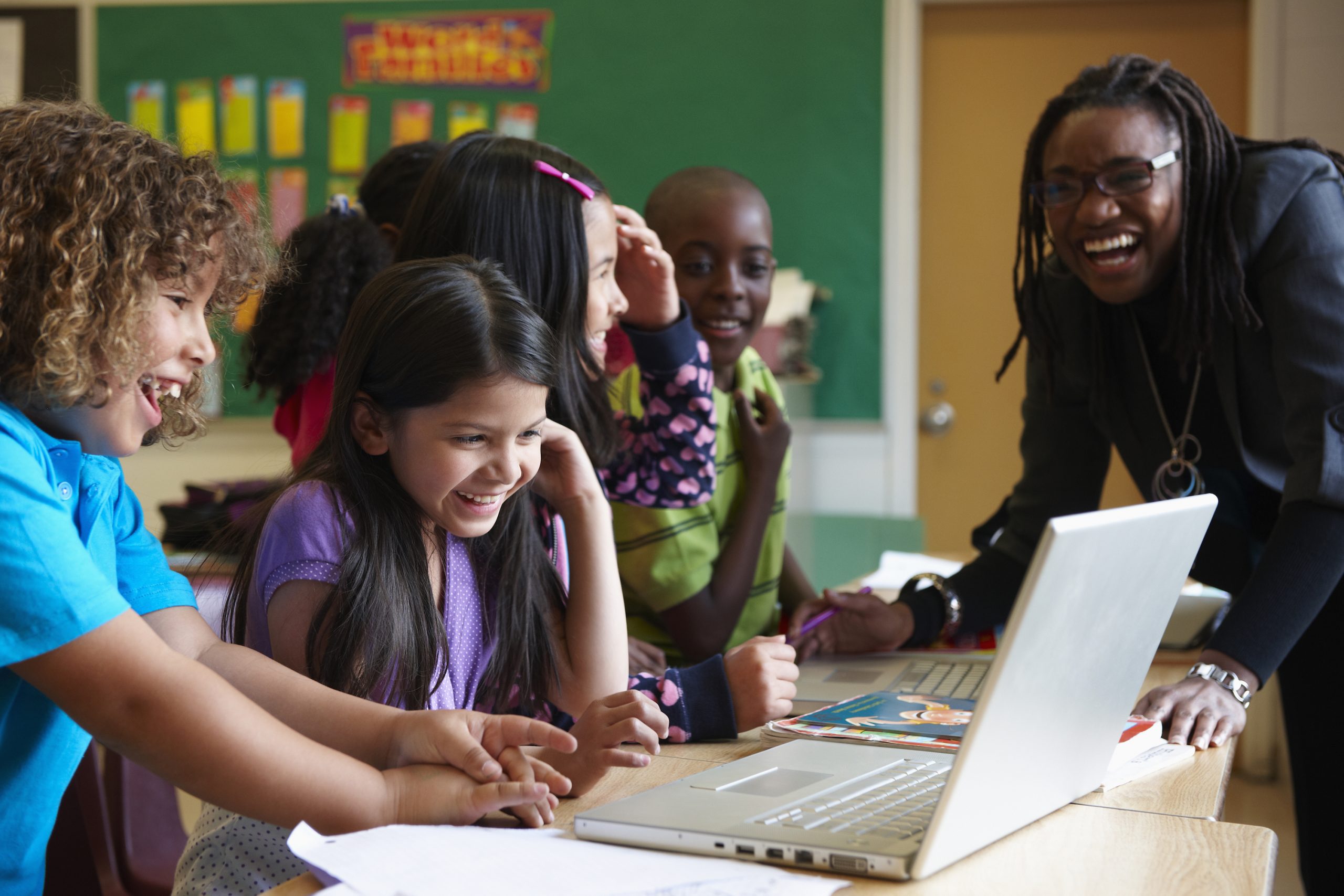 Students using laptop in classroom