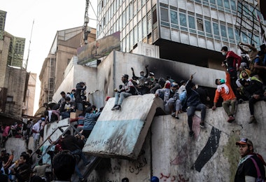 BAGHDAD, IRAQ - NOVEMBER 24: Demonstrators gather on a barricade near Ahrar Bridge where there have been recent clashes between demonstrators and Iraq security forces on November 24, 2019 in Baghdad, Iraq. Thousands of demonstrators have occupied Baghdad's center Tahrir Square and central Baghdad since October 1, calling for government and policy reform. (Photo by Erin Trieb/Getty Images)