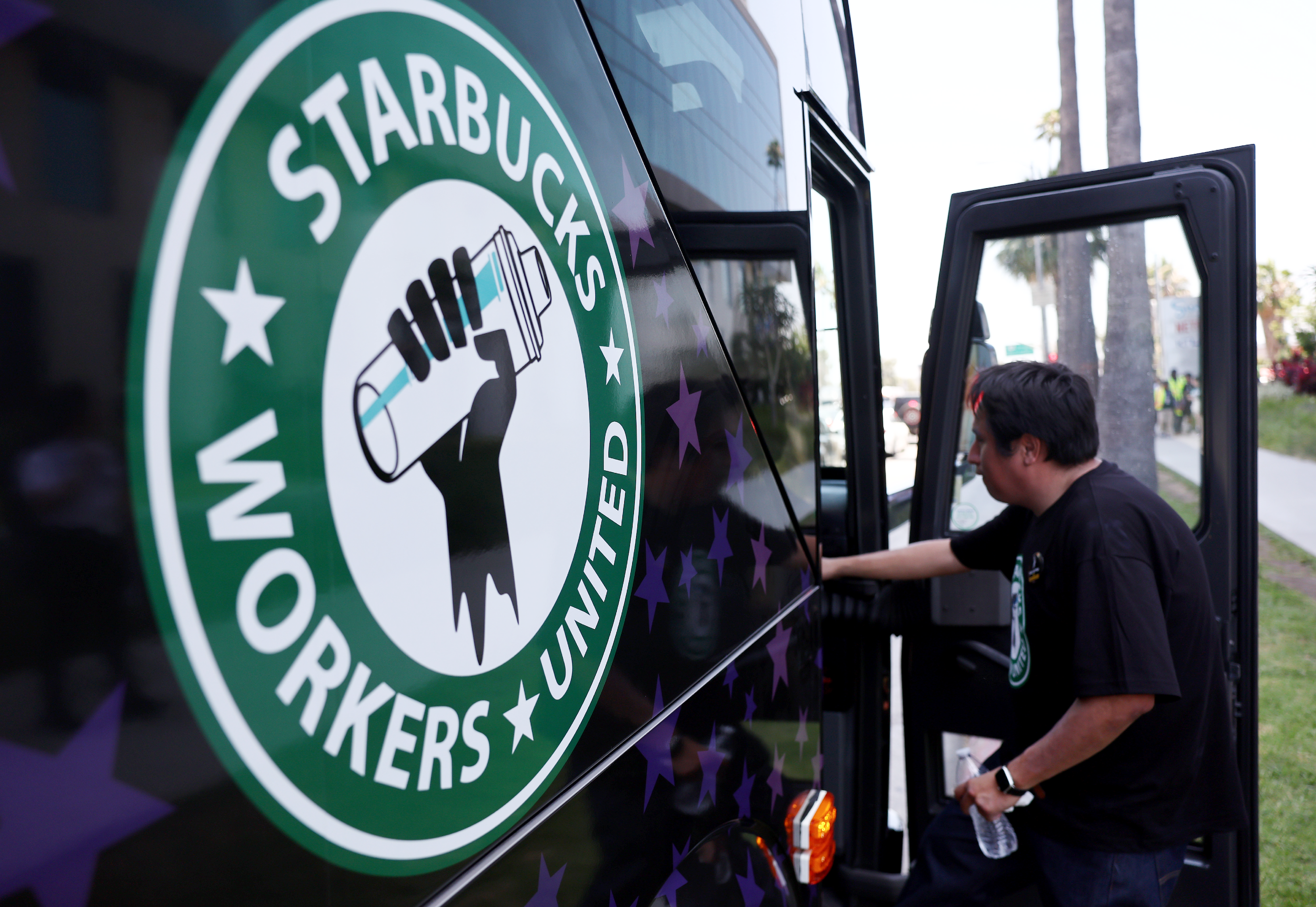A Starbucks worker boards the Starbucks union bus after Starbucks workers stood on the picket line with striking SAG-AFTRA and Writers Guild of America (WGA) members in solidarity outside Netflix studios on July 28, 2023 in Los Angeles, California.