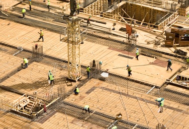 A wide shot of construction workers on a high-rise building.