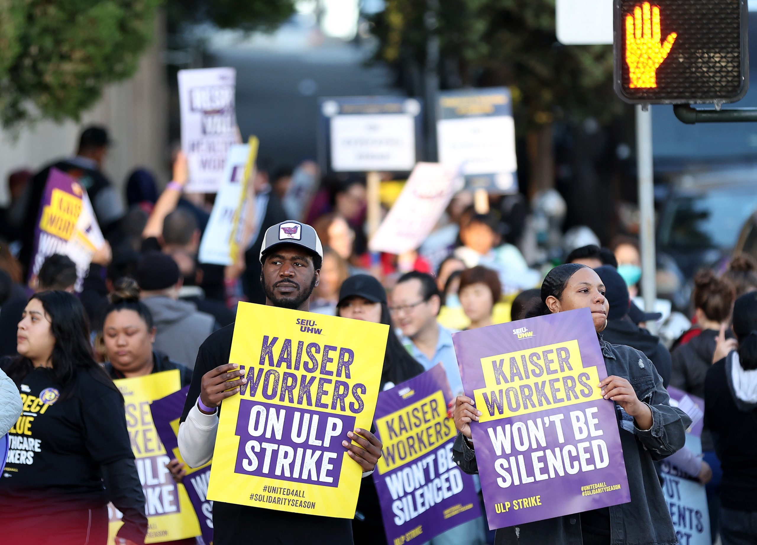 SAN FRANCISCO, CALIFORNIA - OCTOBER 04: Striking Kaiser Permanente workers hold signs as they march in front of the Kaiser Permanente San Francisco Medical Center on October 04, 2023 in San Francisco, California. More than 75,000 Kaiser Permanente workers went on strike Wednesday morning at hospitals and medical facilities in five states after labor negotiators could not reach an agreement to resolve a staffing level dispute. (Photo by Justin Sullivan/Getty Images)
