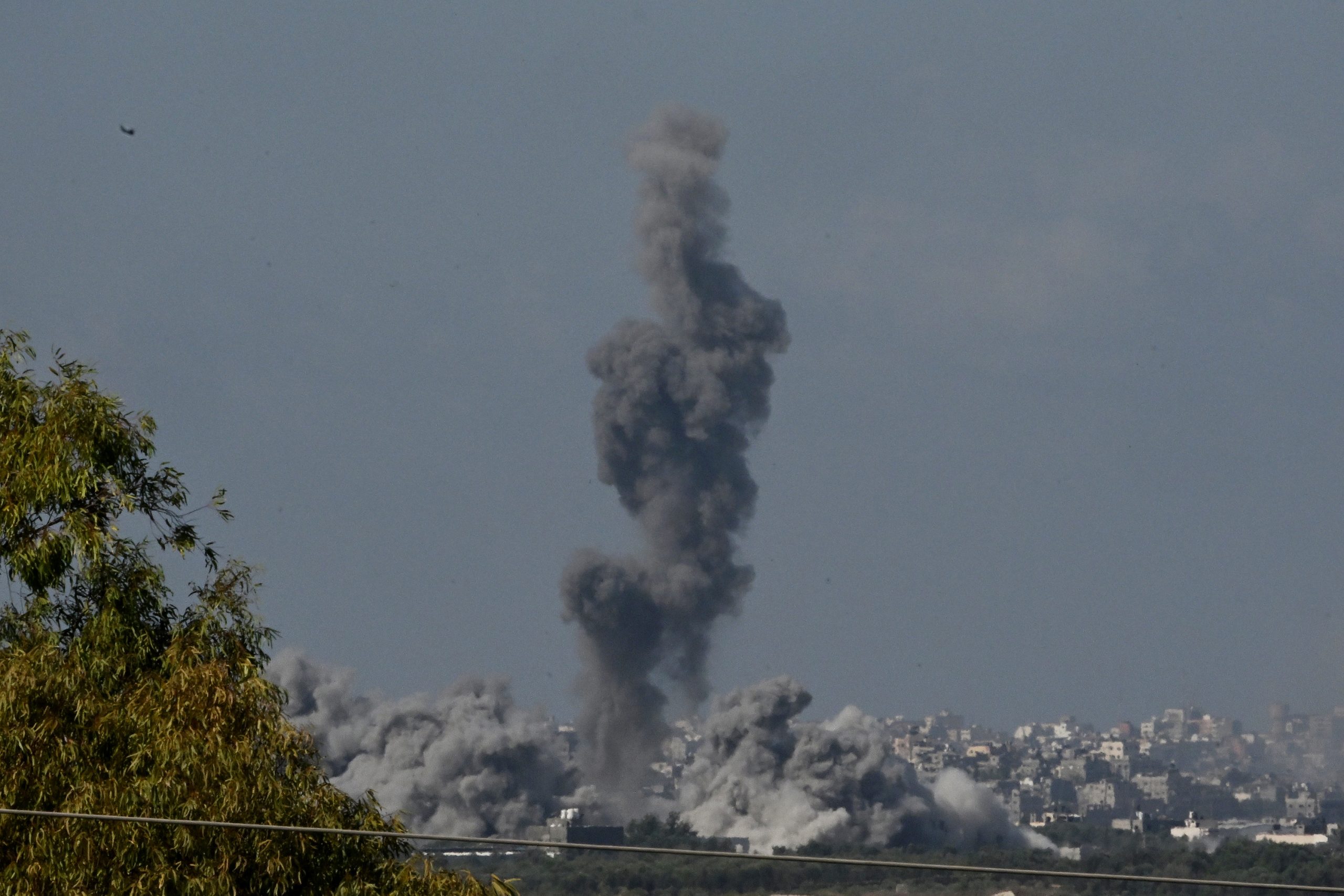 NORTHERN GAZA - OCTOBER 15: Smoke rises from buildings, viewed from the Israeli side of the border, as the Israeli military conducts a bombardment on October 15, 2023 in northern Gaza. Israel has sealed off Gaza and launched sustained retaliatory air strikes, which have killed at least 1,400 people with more than 400,000 displaced, after a large-scale attack by Hamas. On October 7, the Palestinian militant group Hamas launched a surprise attack on Israel from Gaza by land, sea, and air, killing over 1,300 people and wounding around 2,800. Israeli soldiers and civilians have also been taken hostage by Hamas and moved into Gaza. The attack prompted a declaration of war by Israeli Prime Minister Benjamin Netanyahu and the announcement of an emergency wartime government. (Photo by Alexi J. Rosenfeld/Getty Images)