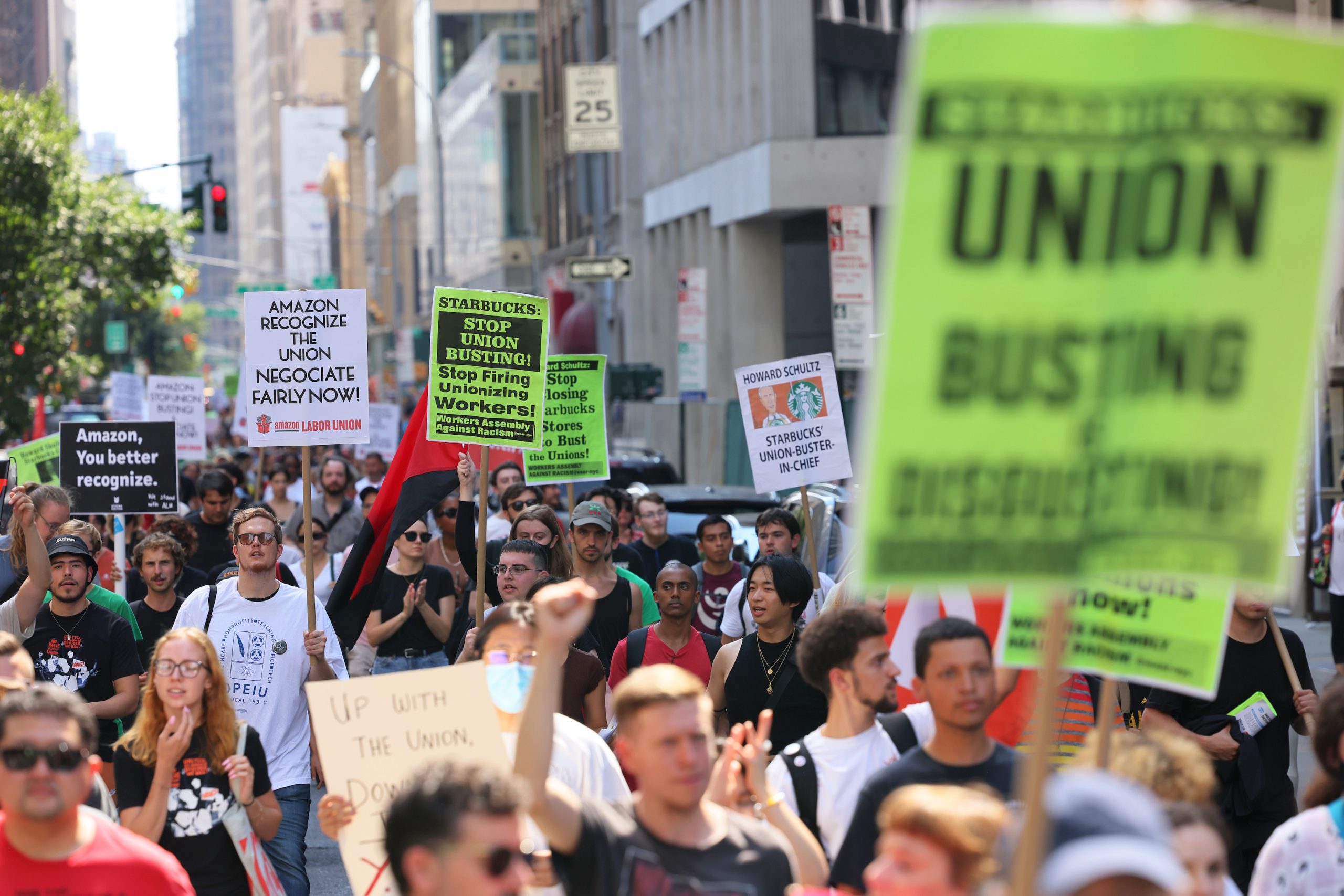 NEW YORK, NEW YORK - SEPTEMBER 05: Pro-union protestors march on Fifth Avenue on September 05, 2022 in New York City. Members of the Amazon Labor Union (ALU) led by Christian Smalls, President of the ALU, and Amazon workers were joined by Starbucks workers, community organizations and pro-union protestors for a Labor Day March for Recognition demanding their unions be recognized by Amazon and Starbucks. The protestors gathered at the NYC homes of Starbucks’ interim CEO Howard Schultz and Amazon CEO Jeff Bezos before holding a rally in Times Square. (Photo by Michael M. Santiago/Getty Images)