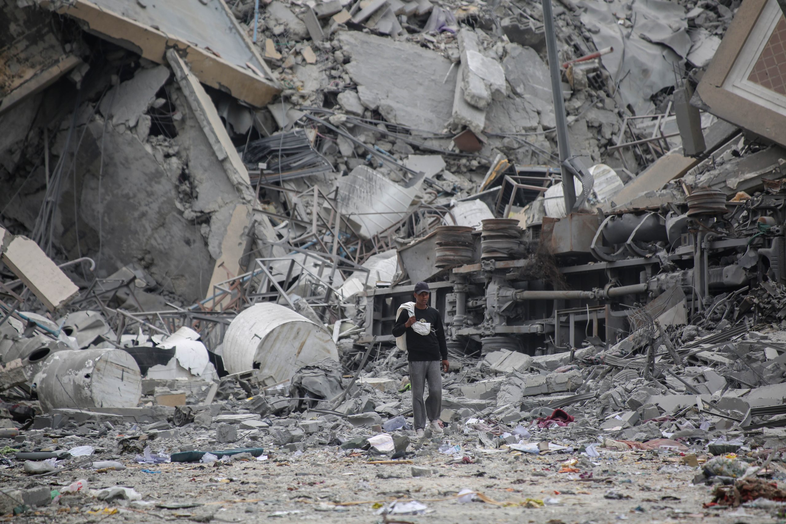 KHAN YUNIS, GAZA – MARCH 17: People inspect the damage and extract items from their homes in Hamad Town after their towers were destroyed by Israeli air strikes on March 17, 2024 in Khan Yunis, Gaza. It is the first time in weeks that medical teams have been able to reach the area, with returning residents finding entire buildings levelled. Khan Yunis is the second-largest urban area after Gaza City and is located in the southern Gaza Strip. It has faced extensive damage, including the destruction of the Al Qarara Cultural Museum during an Israeli attack in October 2023, which targeted civilian homes and mosques. According to Gaza's Ministry of Health, 31,553 Palestinians have been killed, and 73,546 wounded in Israel's ongoing bombardment of Gaza starting on October 7. (Photo by Ahmad Hasaballah/Getty Images)