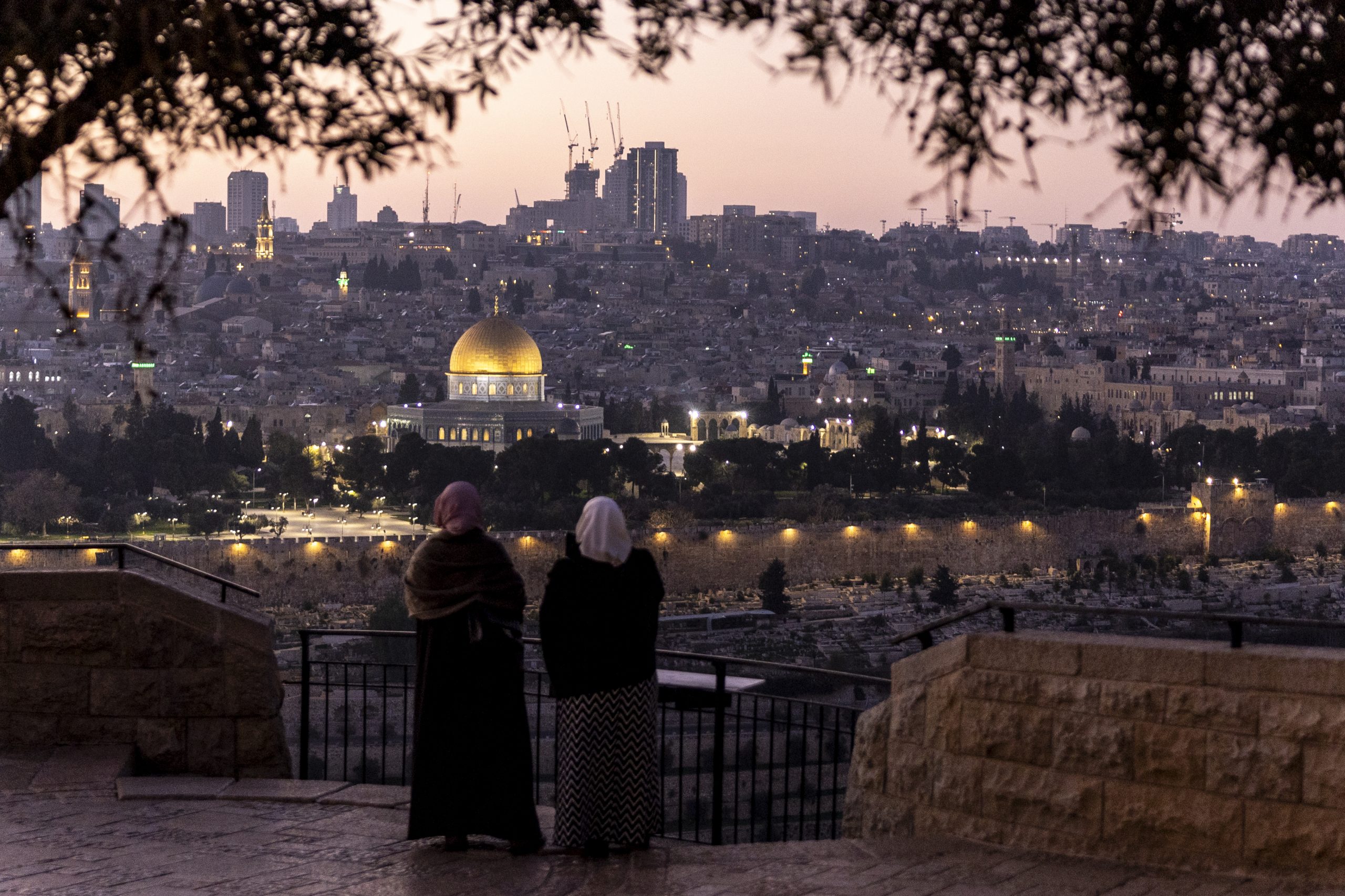 JERUSALEM, ISRAEL - DECEMBER 29: Palestinian women stand at Rekhav'am Observation Point at the Mount of Olives with Al-Aqsa Mosque in the backgroundon December 29, 2023 in Jerusalem. Israel's PM Netanyahu announced an intensification of the fighting in Gaza whilst facing  internal pressure to save hostages. Israel indicated 129 people remain unaccounted for after they were taken as hostages to Gaza during the October 7 attacks by Hamas. (Photo by Maja Hitij/Getty Images)