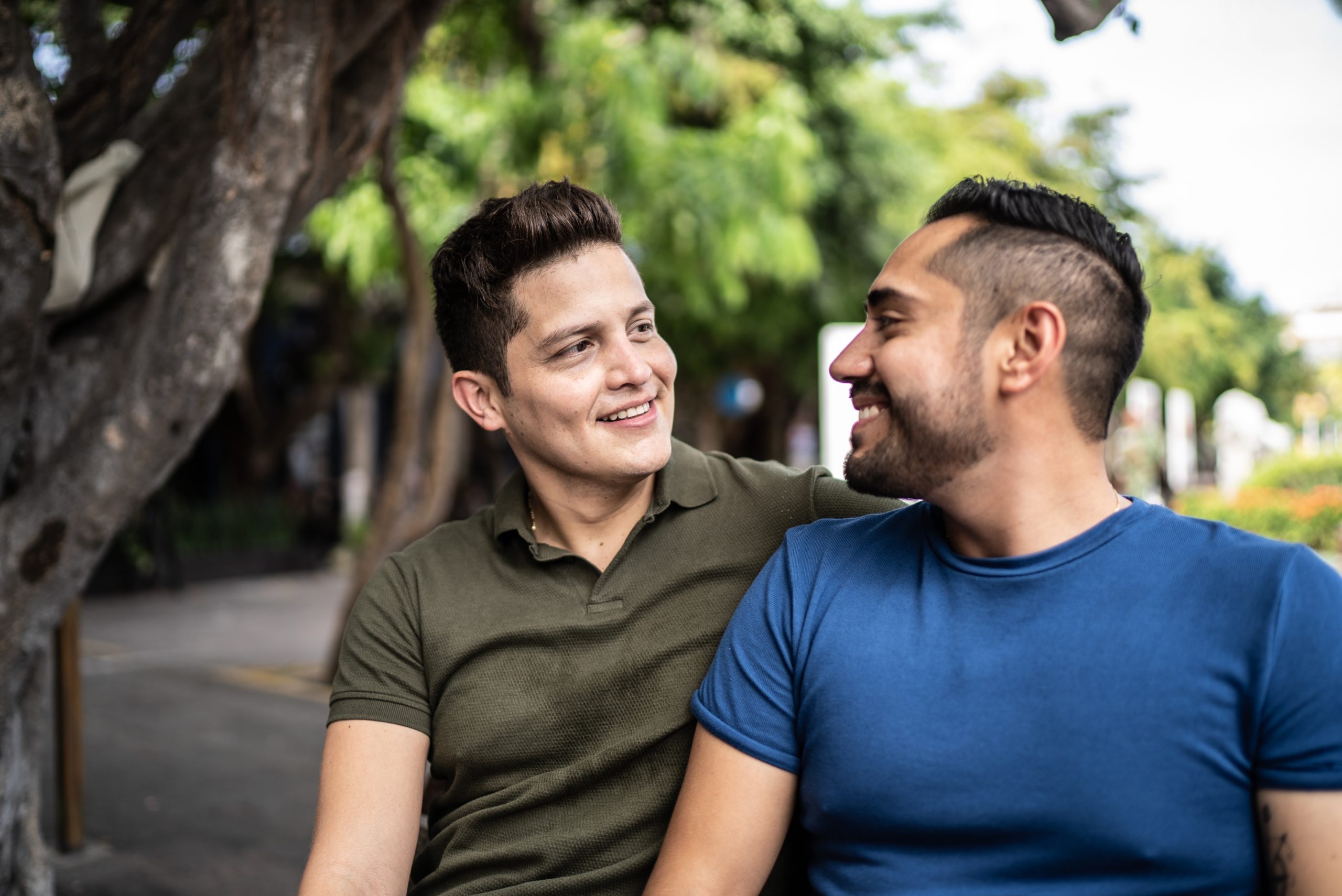 Gay couple talking and sitting at the historic district