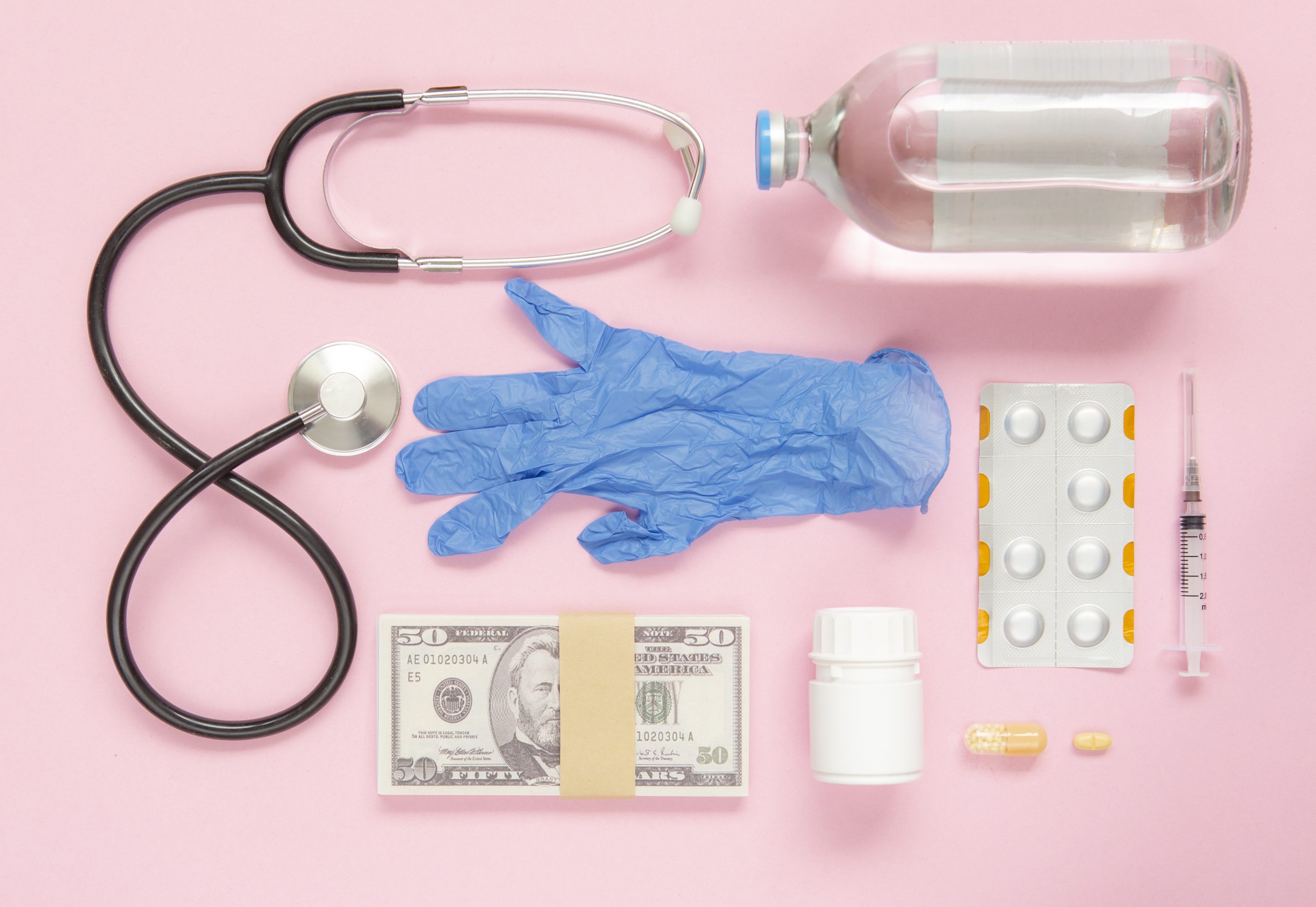 Medicine flat lay on pink color background with money