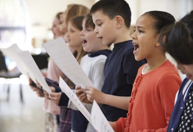 Group Of School Children Singing In Choir Together