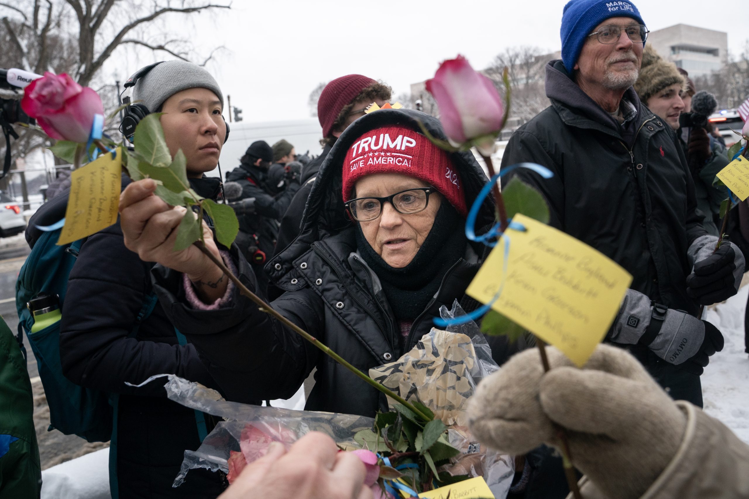 WASHINGTON, DC - JANUARY 6: A supporter of President-elect Donald Trump collects flowers during a memorial for Ashli Babbitt, who was killed on January 6, 2021, near the U.S. Capitol on January 6, 2025 in Washington, DC. The group laid flowers and called for the release of those imprisoned for their actions on January 6. (Photo by Nathan Howard/Getty Images)