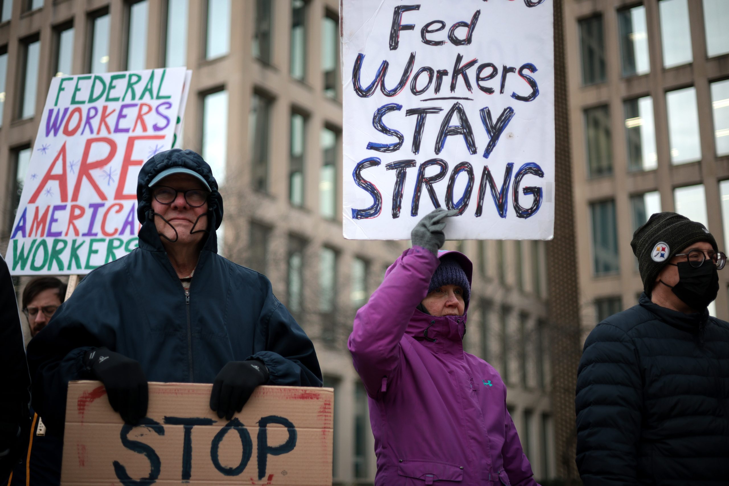 WASHINGTON, DC - FEBRUARY 05: Protesters rally outside of the Theodore Roosevelt Federal Building headquarters of the U.S. Office of Personnel Management on February 05, 2025 in Washington, DC. The group of federal employees and supporters are protesting against Elon Musk, tech billionaire and head of the Department of Government Efficiency (DOGE), and his aids who have been given access to federal employee personal data and have allegedly locked out career civil servants from the OPM computer systems. (Photo by Alex Wong/Getty Images)