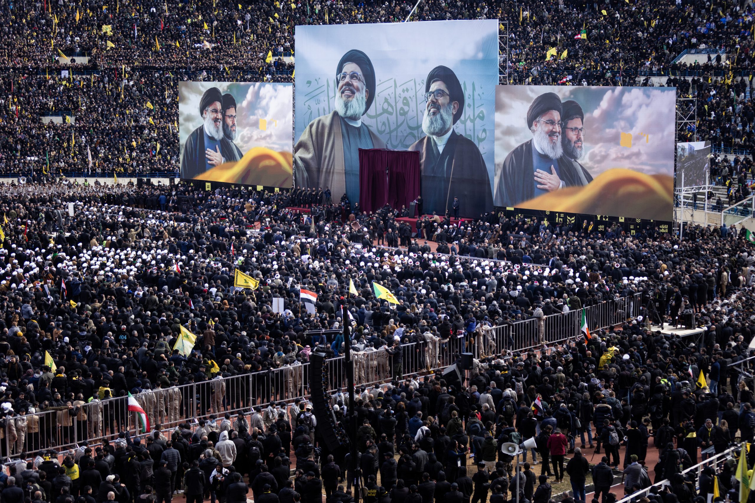 BEIRUT, LEBANON - FEBRUARY 23: An illustration of former Hezbollah leaders, Hassan Nasrallah, left, and Hashem Safieddine, are seen at the stage for their funerals at the Sports City Stadium on February 23, 2025 in Beirut, Lebanon. Tens of thousands of people have gathered in Beirut to attend the funeral of Hezbollah's former leader, Hassan Nasrallah, nearly five months after he was killed in an Israeli airstrike on a southern suburb of the Lebanese capital. Nasrallah founded and led the Shi'ite Muslim group for 30 years, through decades of conflict with Israel and became one of the most prominent Arab figures in generations. (Photo by Daniel Carde/Getty Images)