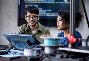 Build a Software Development Team to Running Your Business Growth. Software Engineers on the project discuss a database design workflow and technical issues in a tech business office.