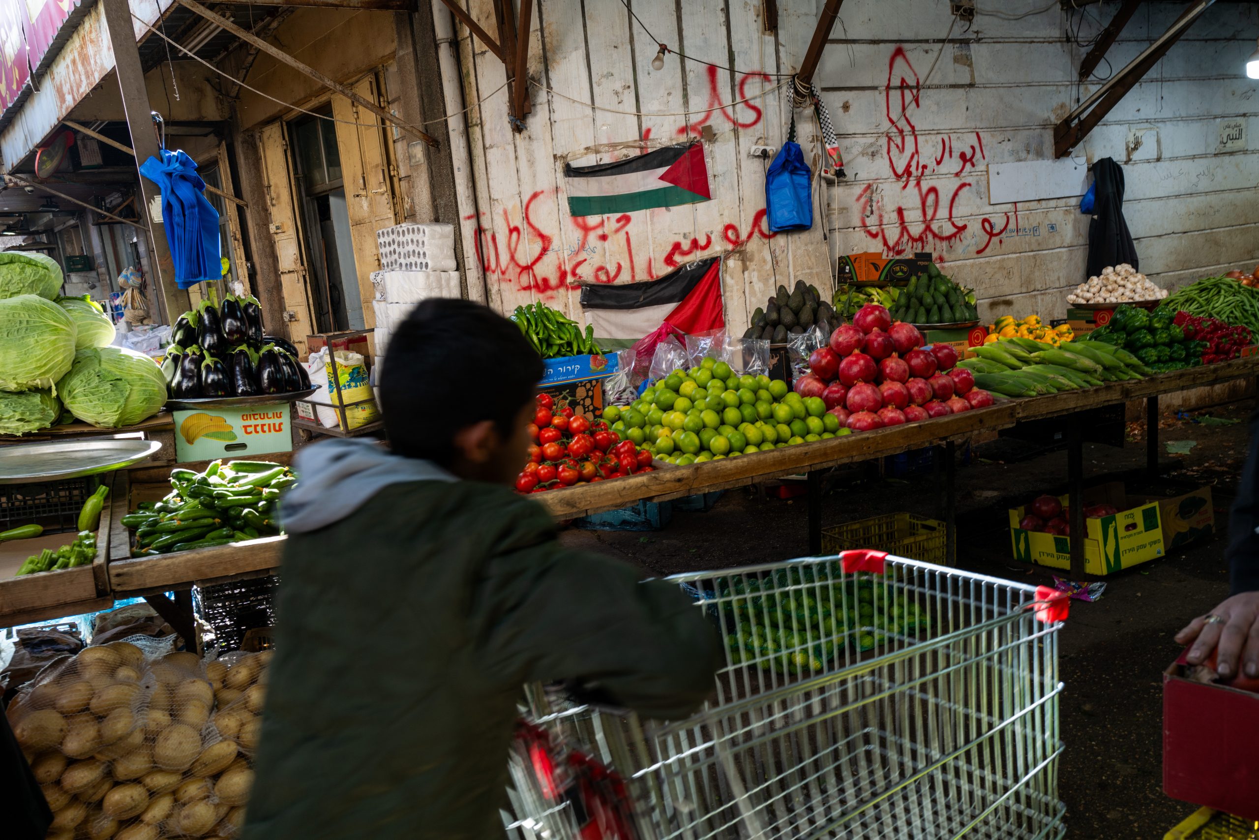 RAMALLAH - DECEMBER 09: People walk through a market in central Ramallah on December 09, 2023 in Ramallah. According to new estimates by the United Nations Development Program (UNDP), if the war in Gaza continues for a second month the poverty rate in the State of Palestine will rise by 34 percent, placing nearly half a million additional people into poverty. Israel's war against Hamas that was sparked by the Oct. 7 attacks has also made life more volatile in East Jerusalem and the West Bank. Israeli forces here have stepped up raids on alleged militants, police have clashed with protesters, and there has been a rise in violent attacks on Palestinians by Israeli settlers. Last month, Hamas also claimed responsibility for a deadly shooting in Jerusalem by two brothers from the eastern part of the city. (Photo by Spencer Platt/Getty Images)