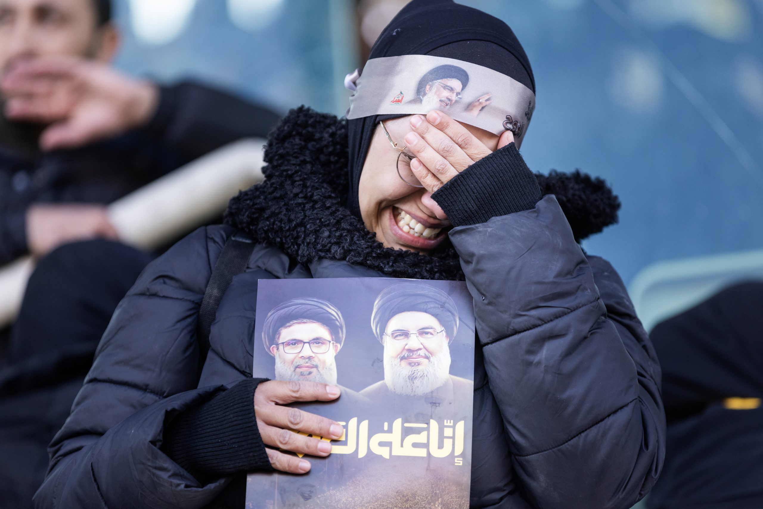 BEIRUT, LEBANON - FEBRUARY 23: A woman cries during the funerals for former Hezbollah leaders Hassan Nasrallah and Hashem Safieddine at the Sports City Stadium on February 23, 2025 in Beirut, Lebanon. Tens of thousands of people have gathered in Beirut to attend the funeral of Hezbollah's former leader, Hassan Nasrallah, nearly five months after he was killed in an Israeli airstrike on a southern suburb of the Lebanese capital. Nasrallah founded and led the Shi'ite Muslim group for 30 years, through decades of conflict with Israel and became one of the most prominent Arab figures in generations. (Photo by Daniel Carde/Getty Images)