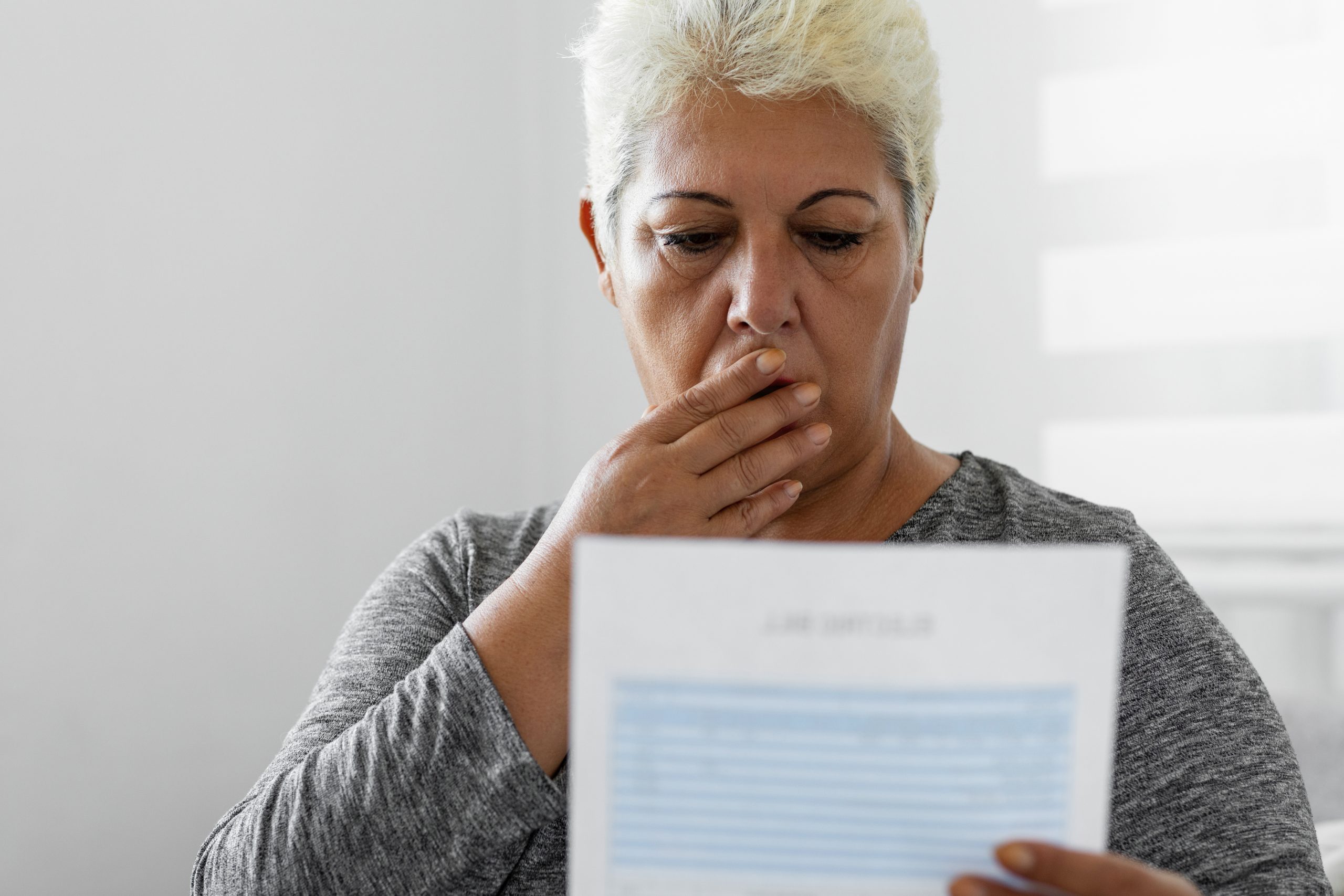 Mature woman checking her energy bills at home