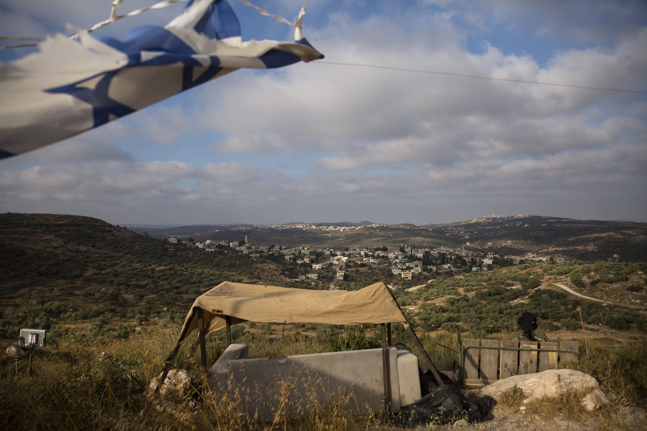 HAR HEMED, ISRAEL - JUNE 26:  An Israeli soldier looks at the Palestinian village of Kfar Kadum as she is guarding the Jewish settlement of Har Hemed near Nablus on June 26, 2020 in Har Hemed, West Bank. While Prime Minister Netanyahu favors a more aggressive plan for unilateral annexation, his coalition partner Benny Gantz, and Foreign Minister Gabi Ashkenazi, have struck a more reticent note.  (Photo by Amir Levy/Getty Images)